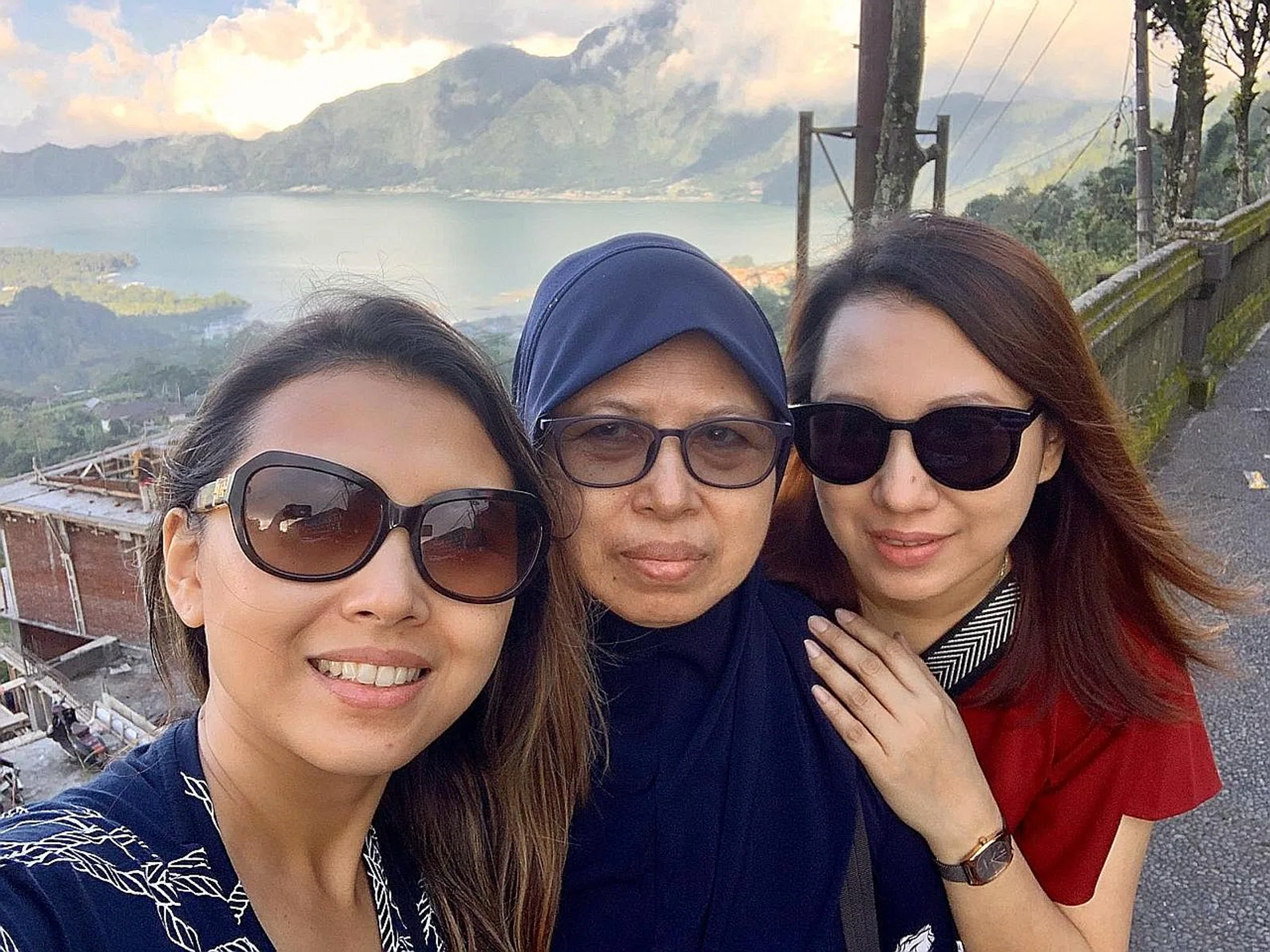 Ms Tanty Rosli with her mother (far left). They had to cut short their Bali trip with other family members.