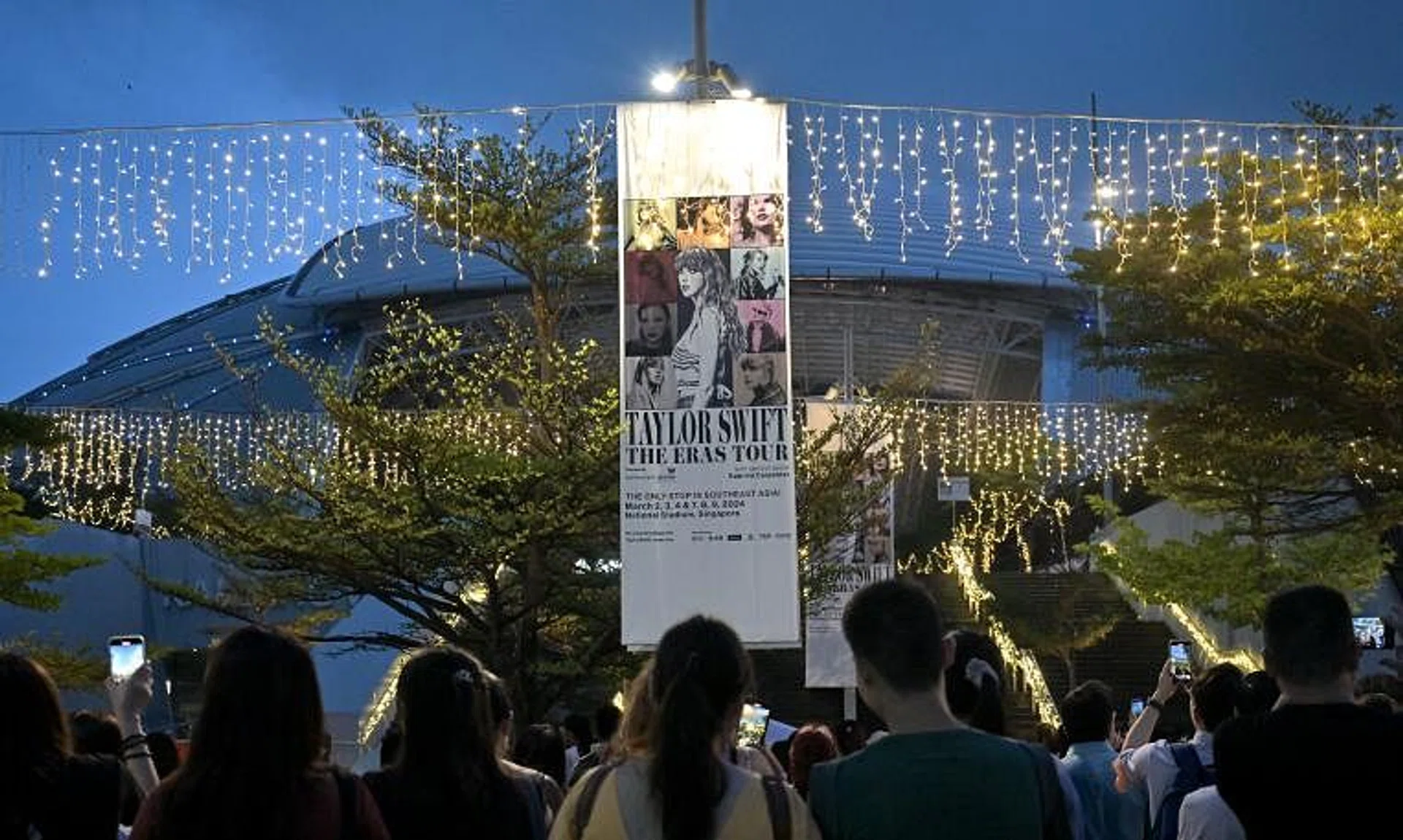 Fans without tickets enjoying one of  Taylor Swift's concerts outside the National Stadium earlier in March.