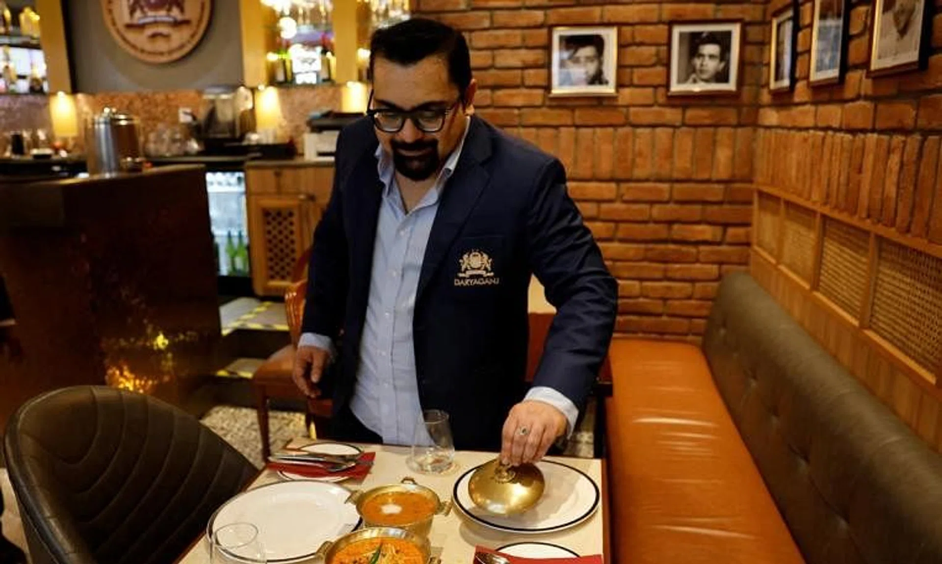 FILE PHOTO: Amit Bagga, CEO of Daryaganj restaurant, shows a freshly prepared butter chicken dish and the lentil dish Dal Makhani inside Daryaganj restaurant at a mall, in Noida, India, January 23, 2024. REUTERS/Sahiba Chawdhary/File Photo