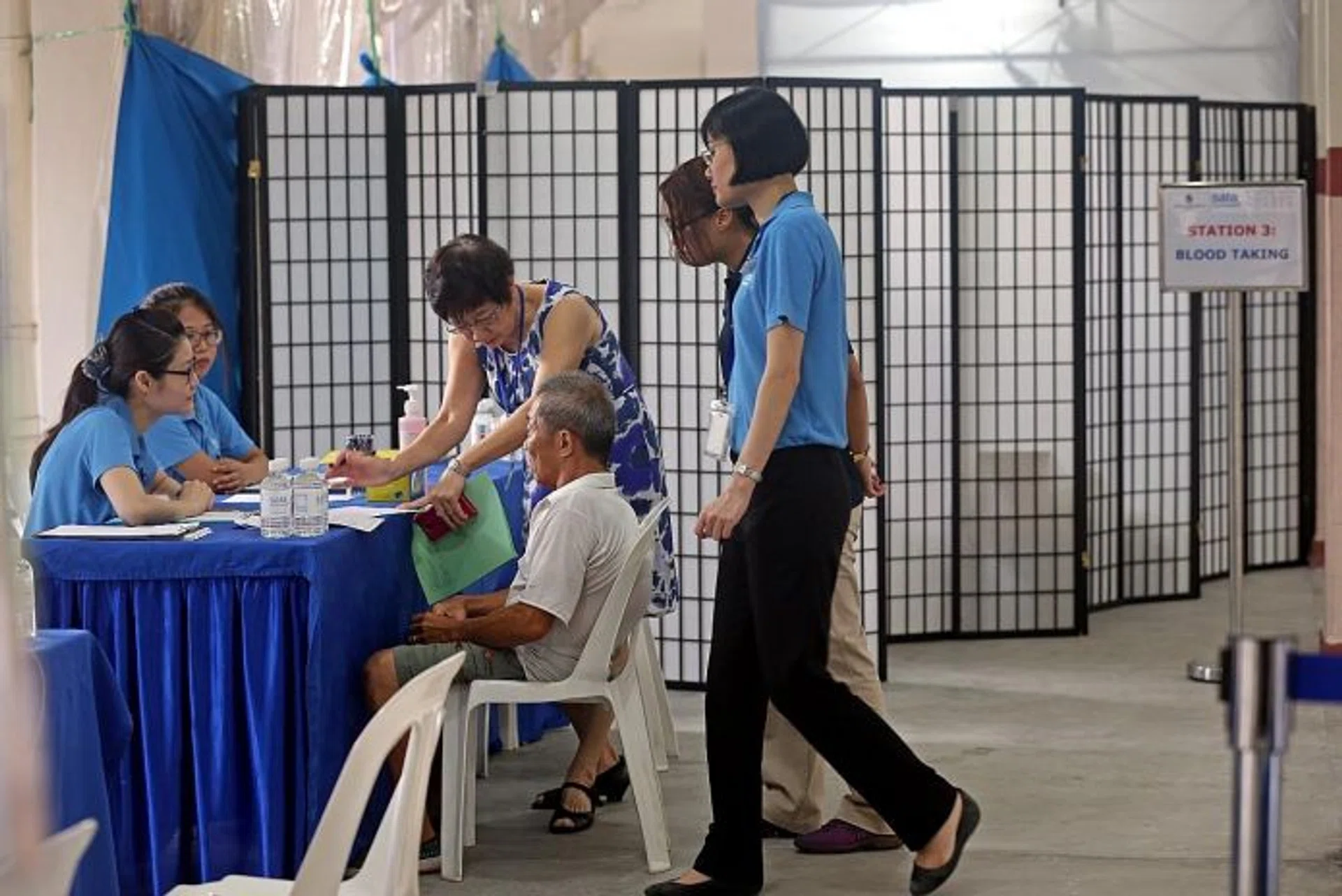 SCREENED: Residents at Blk 203 Ang Mo Kio Ave 3 undergoing the tuberculosis screening