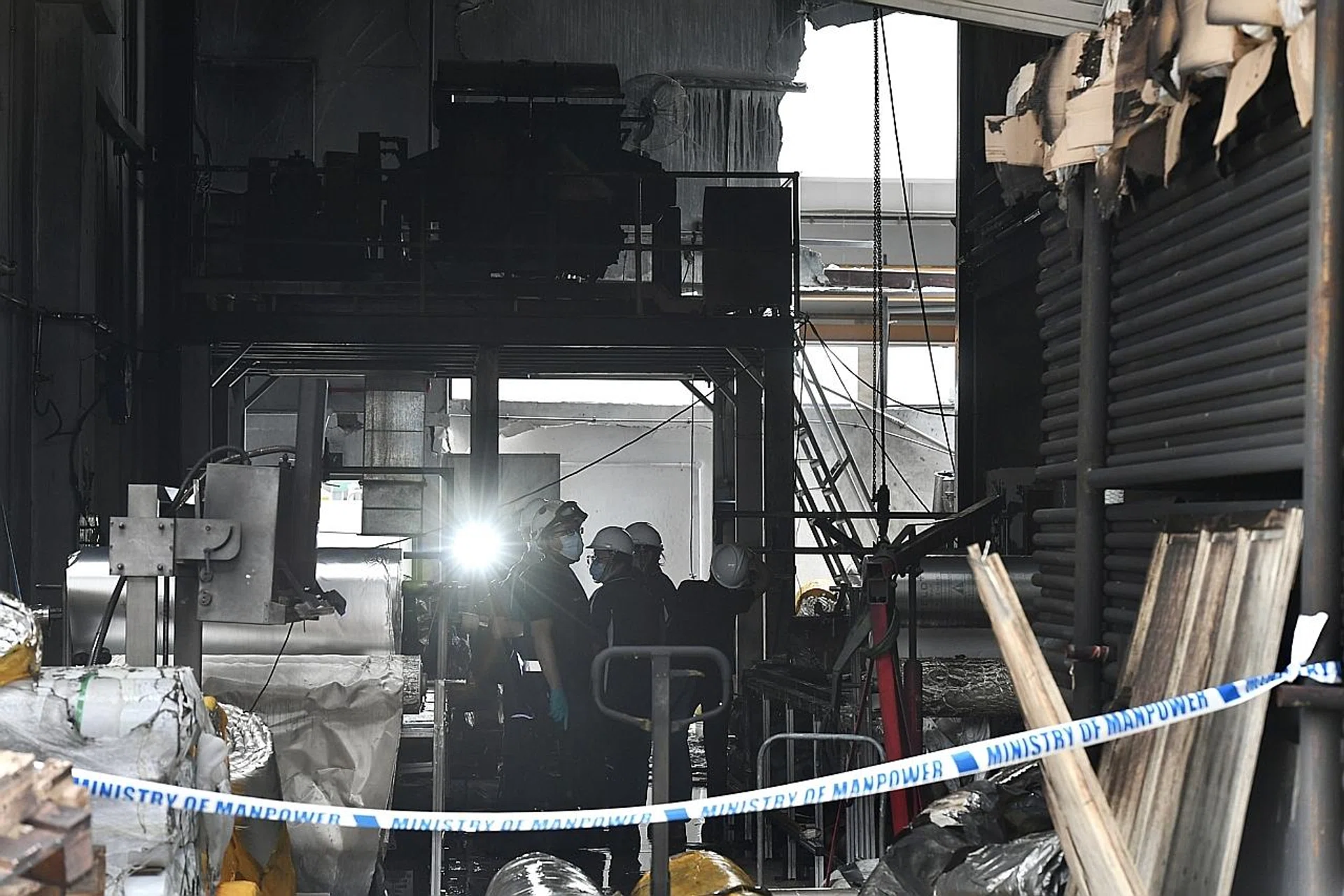 A fire investigation team is entering the site of the incident. 