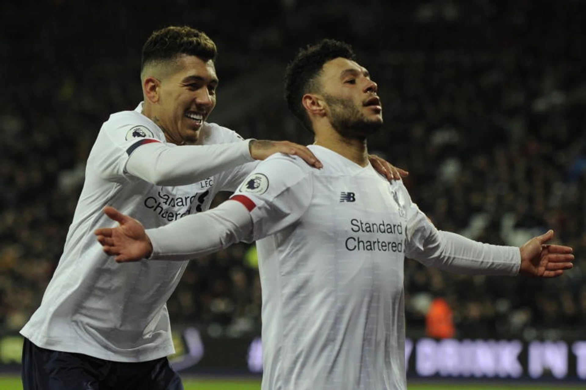 Liverpool's Roberto Firmino (left) celebrating with Alex Oxlade-Chamberlain after the Englishman made it 2-0.