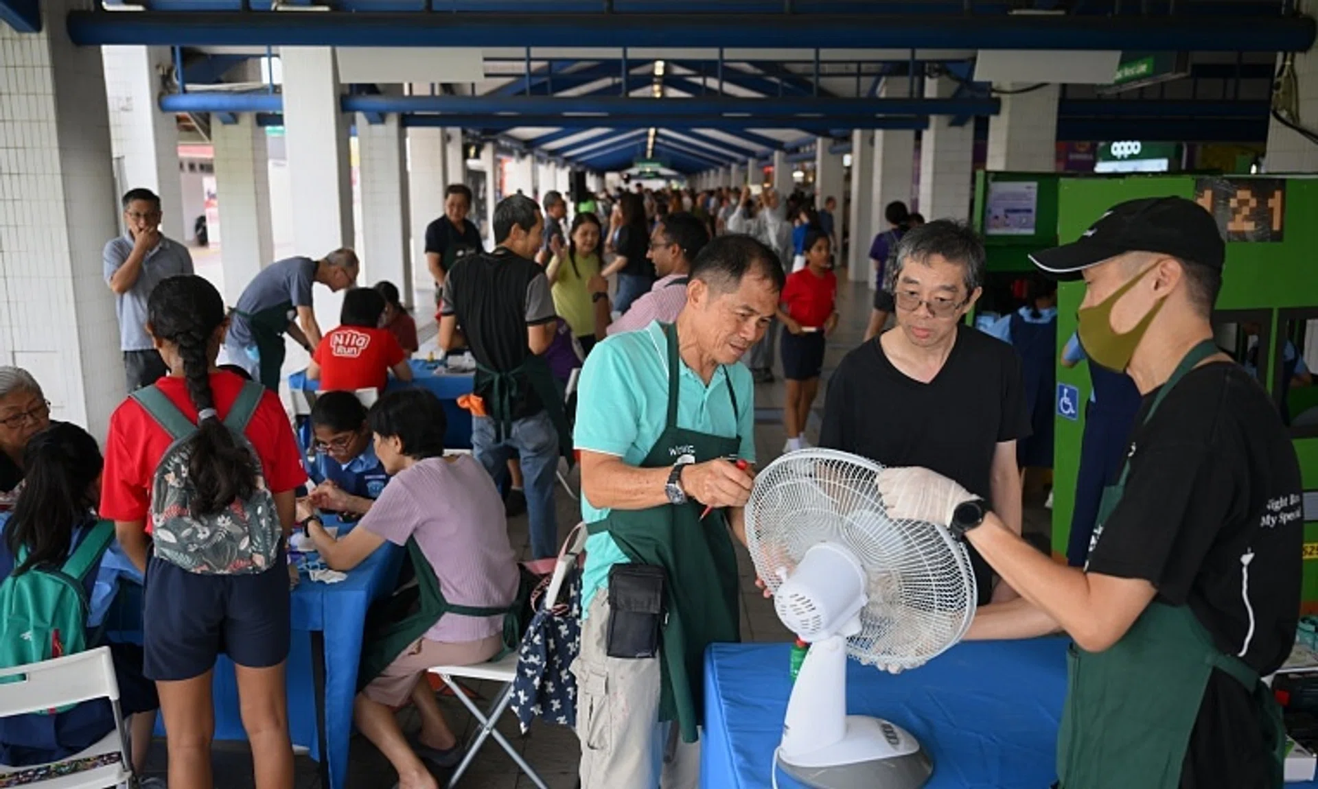 Mr Richard Lee (second from right) learning from Repair Kopitiam volunteers Edmund Ho (right) and Wong Tuan Wah at the repair clinic on Oct 26.