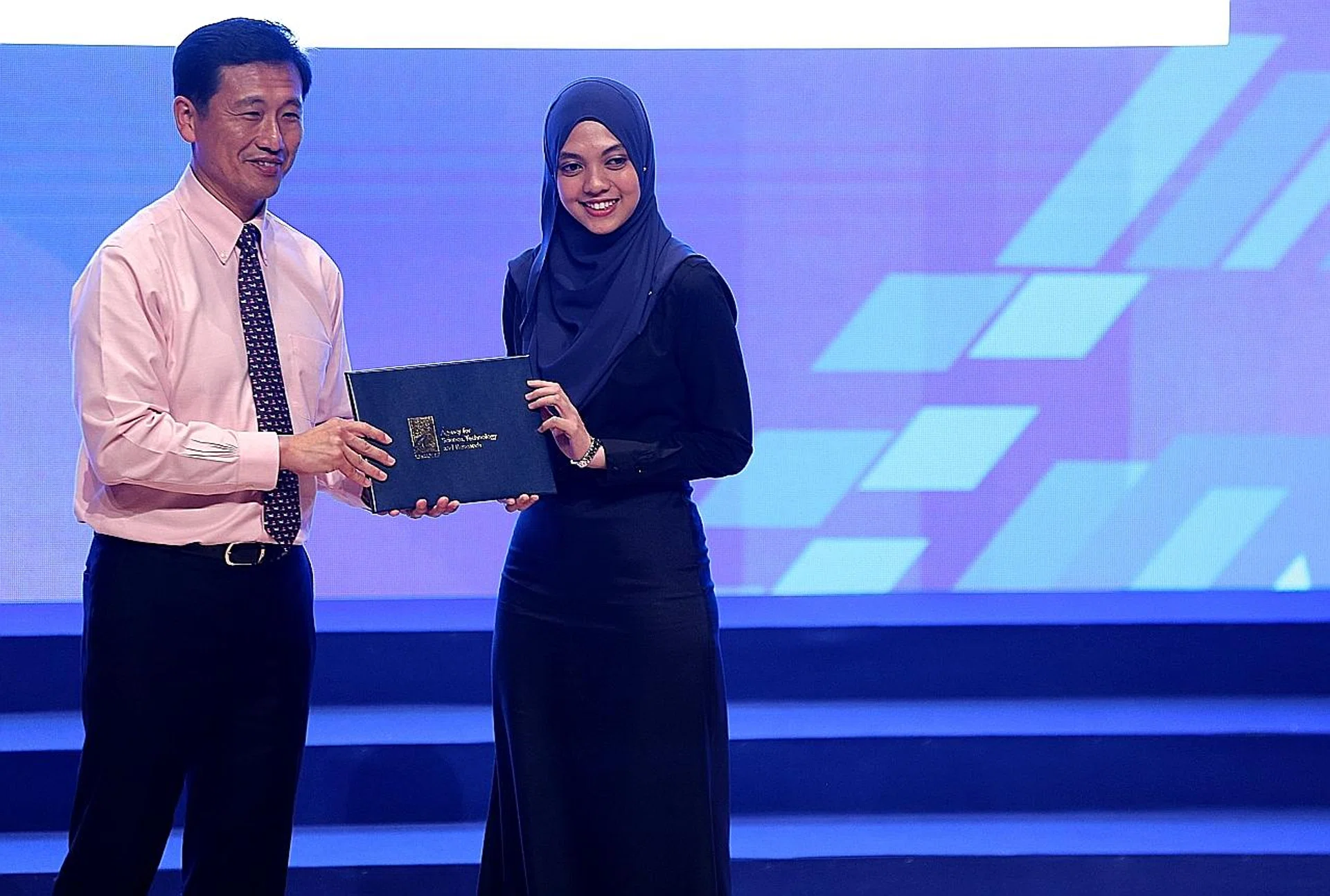 Ms Nazihah Husna receiving her A*Star Graduate Scholarship award from Mr Ong Ye Kung, Minster for Education . 