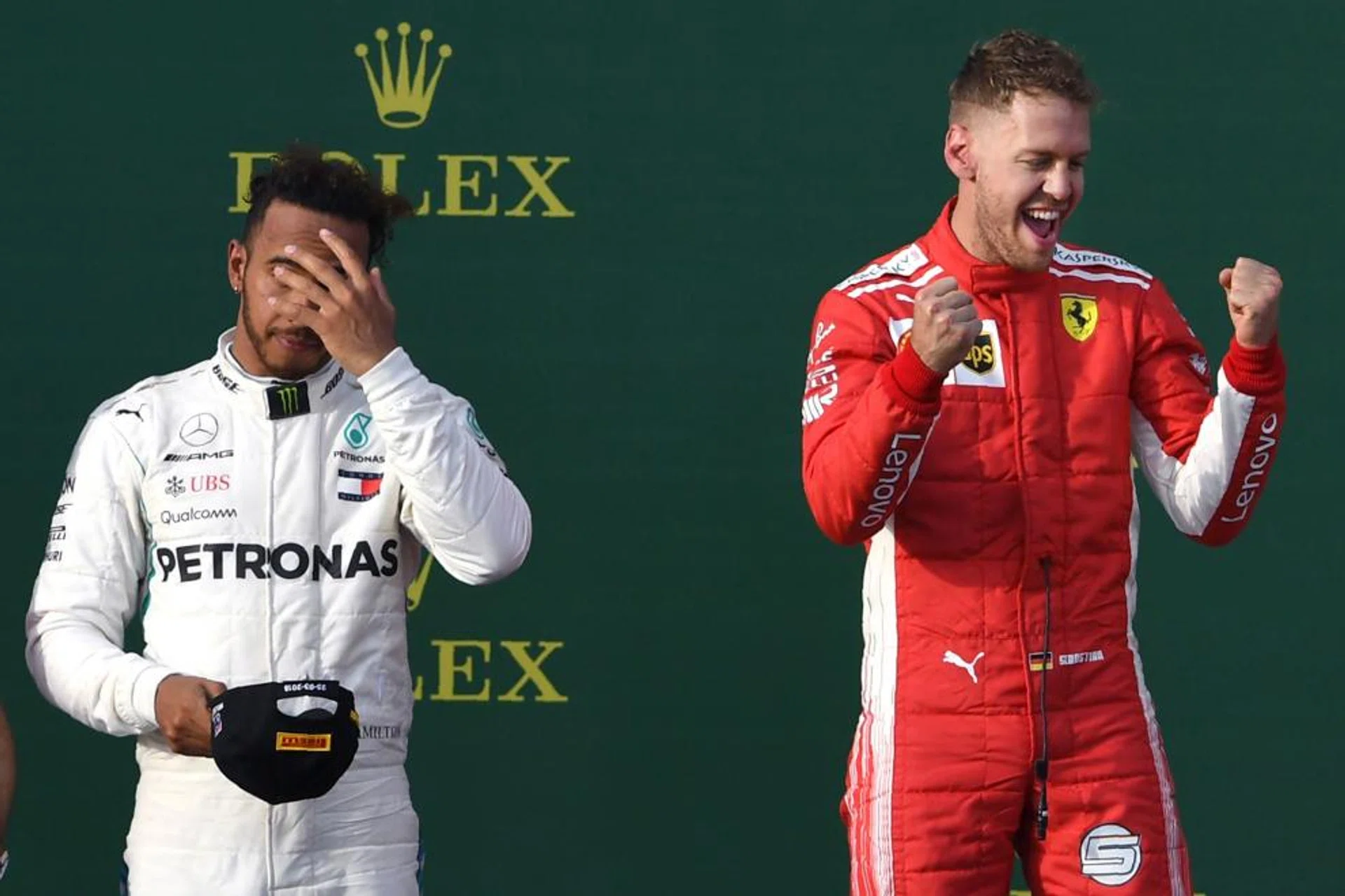 Ferrari's Sebastian Vettel (right) celebrates on the podium as Lewis Hamilton ponders a return to the drawing board for Mercedes.