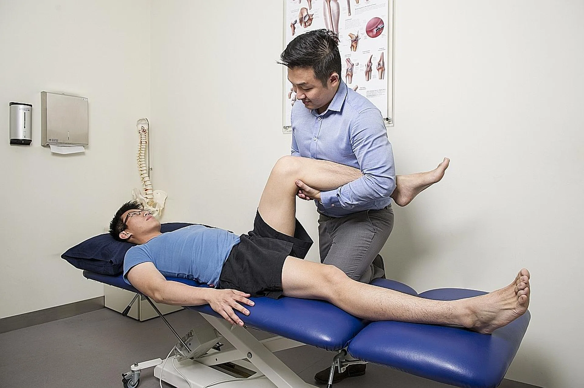 Mr Chng Chye Tuan helping a patient. 