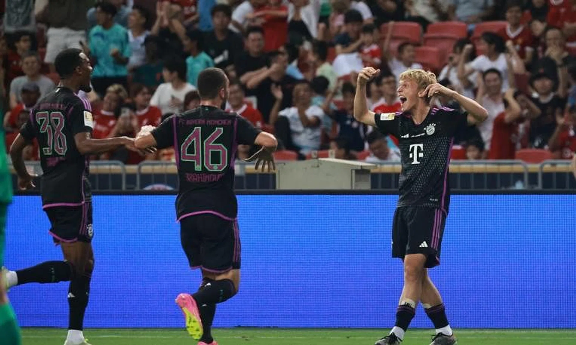 Bayern Munich’s Franz Kratzig (right) celebrates scoring the winning goal with teammates Ryan Gravenberch (left) and Arijon Ibrahimovic in the Singapore Festival of Football friendly match between Liverpool and Bayern Munich on Wdnesday