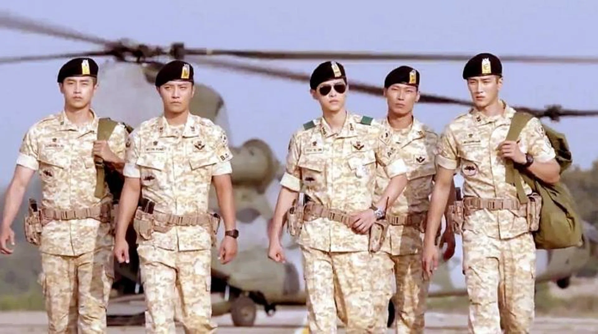 ARMY DAYS: Captain Yoo Si Jin (Song Joong Ki, with sunglasses) and Sergeant Major Seo Dae Young (Jin Goo, second from left) in a scene from Descendants Of The Sun.