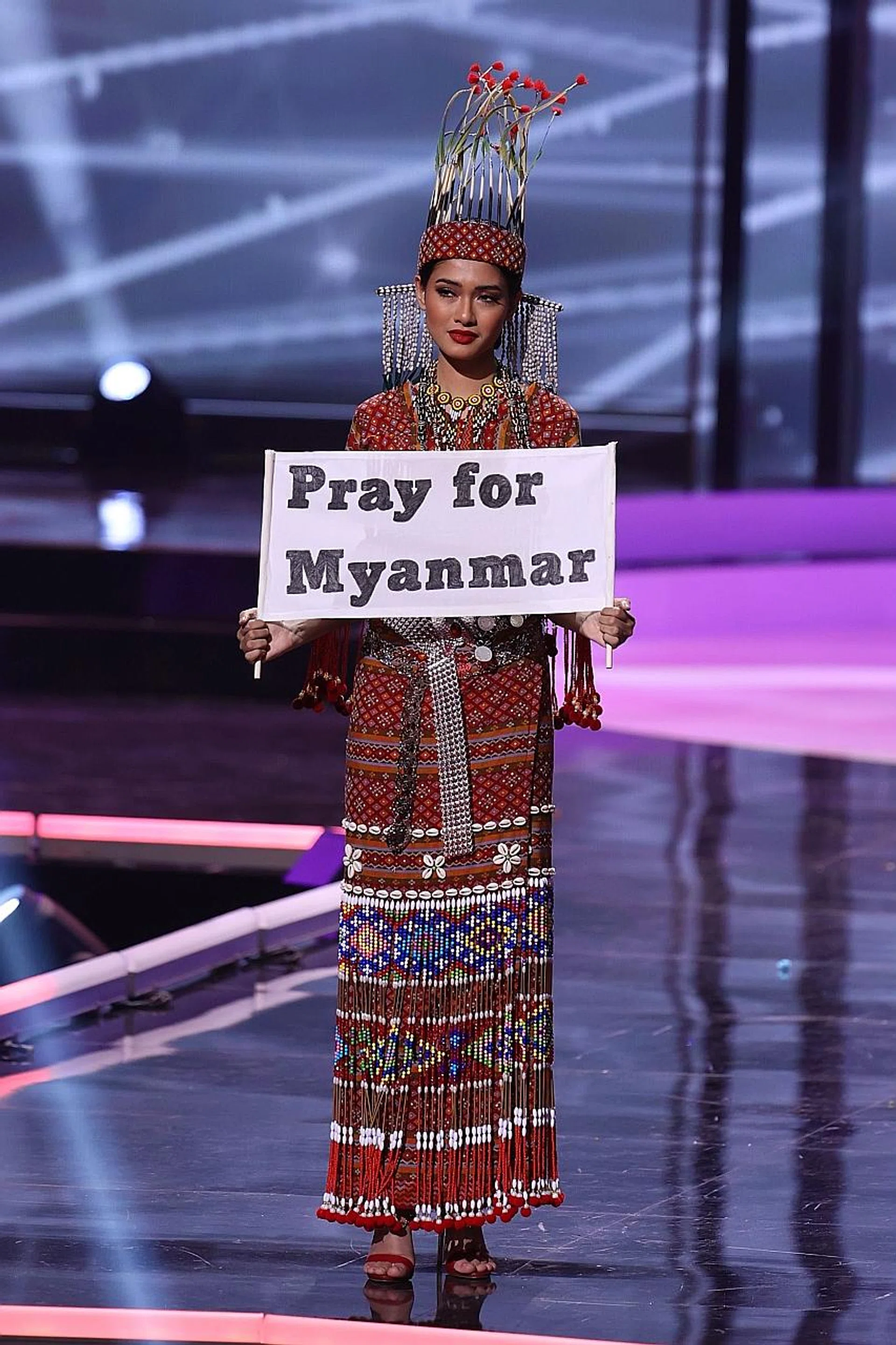 Miss Andrea Meza of Mexico after winning the title. Singapore's Bernadette Belle Ong in her national costume. Myanmar's Thuzar Wint Lwin urges support for protesters. 