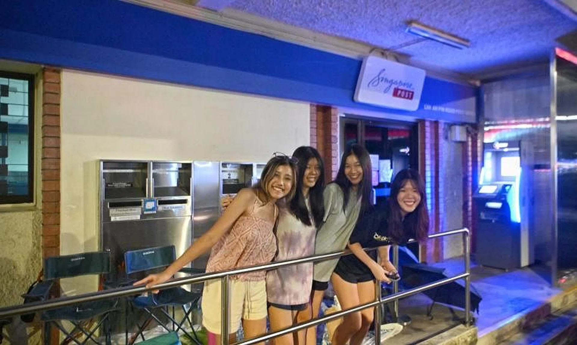 (From left) Polytechnic student Nellie Titus and her friends Rebekah Loh, Megan Choy and Lynette Saw turned up at Lim Ah Pin Post Office in Kovan on Wednesday at 10.30pm.