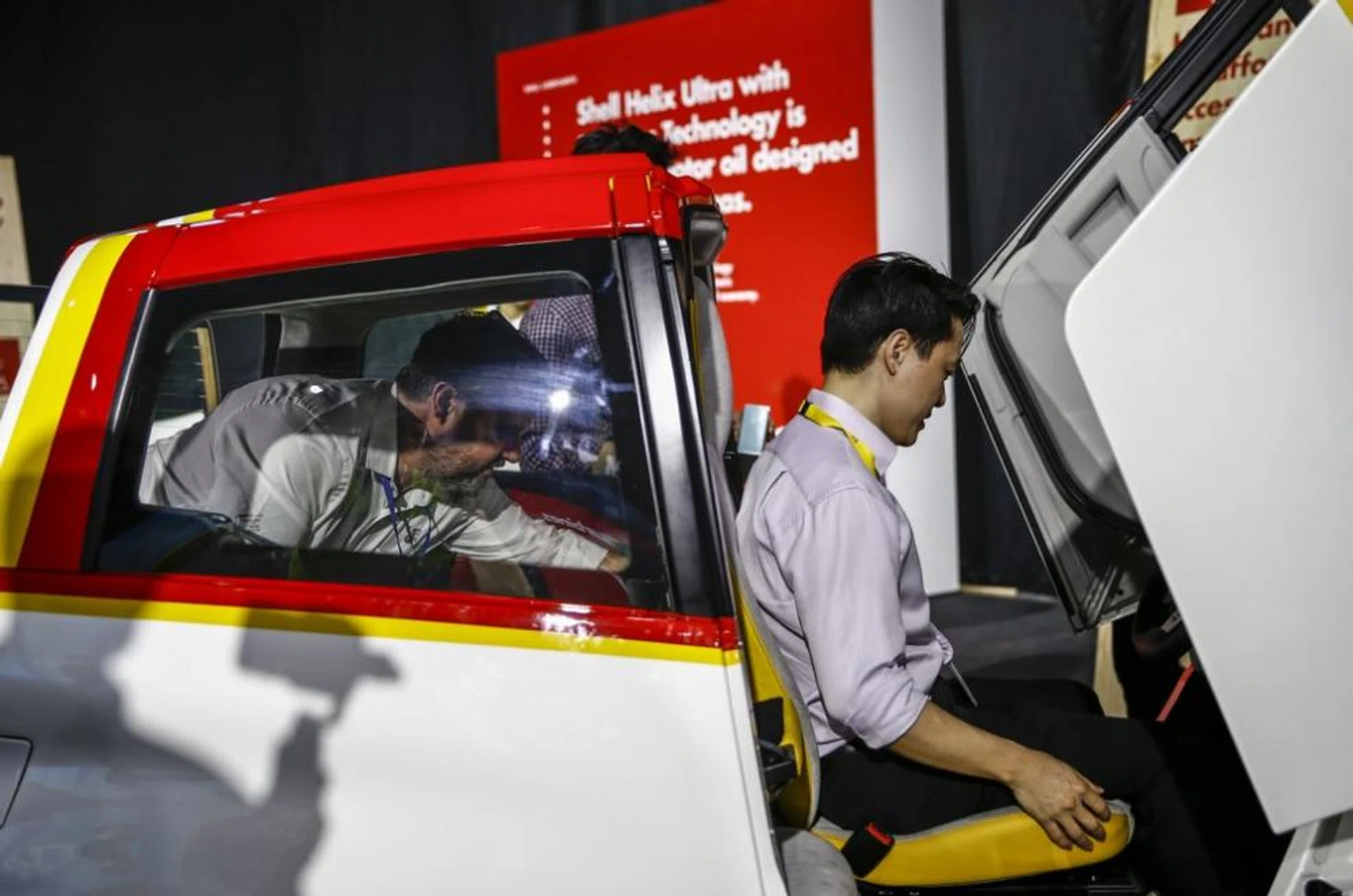Two visitors inspect the Shell concept car at the Shell 'Make the Future' festival at the Changi Exhibition Centre in Singapore, 16 March 2017. The festival features various exhibits showcasing future sources of energy as well as the Shell Eco-Marathon where students from various tertiary institutions will build and race energy-efficient cars. 