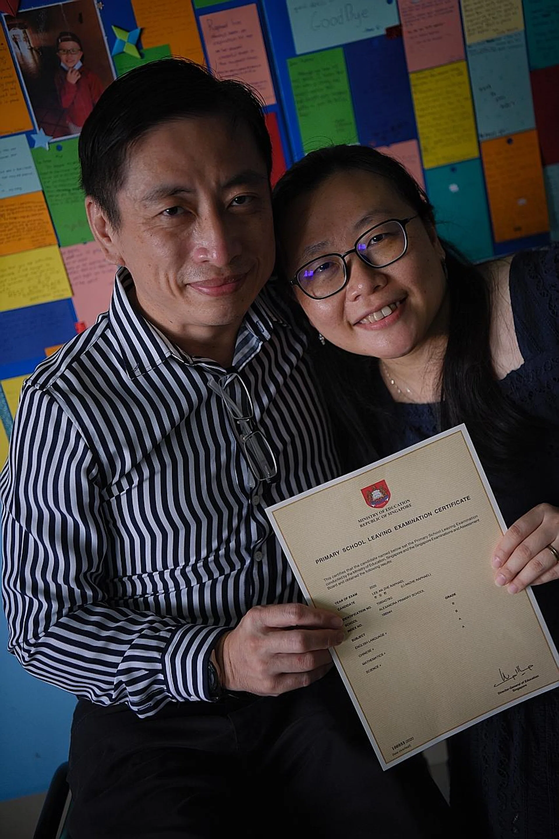 Raphael's parents, Mr William Lee and Mrs Winnie Lee, with his PSLE results. 