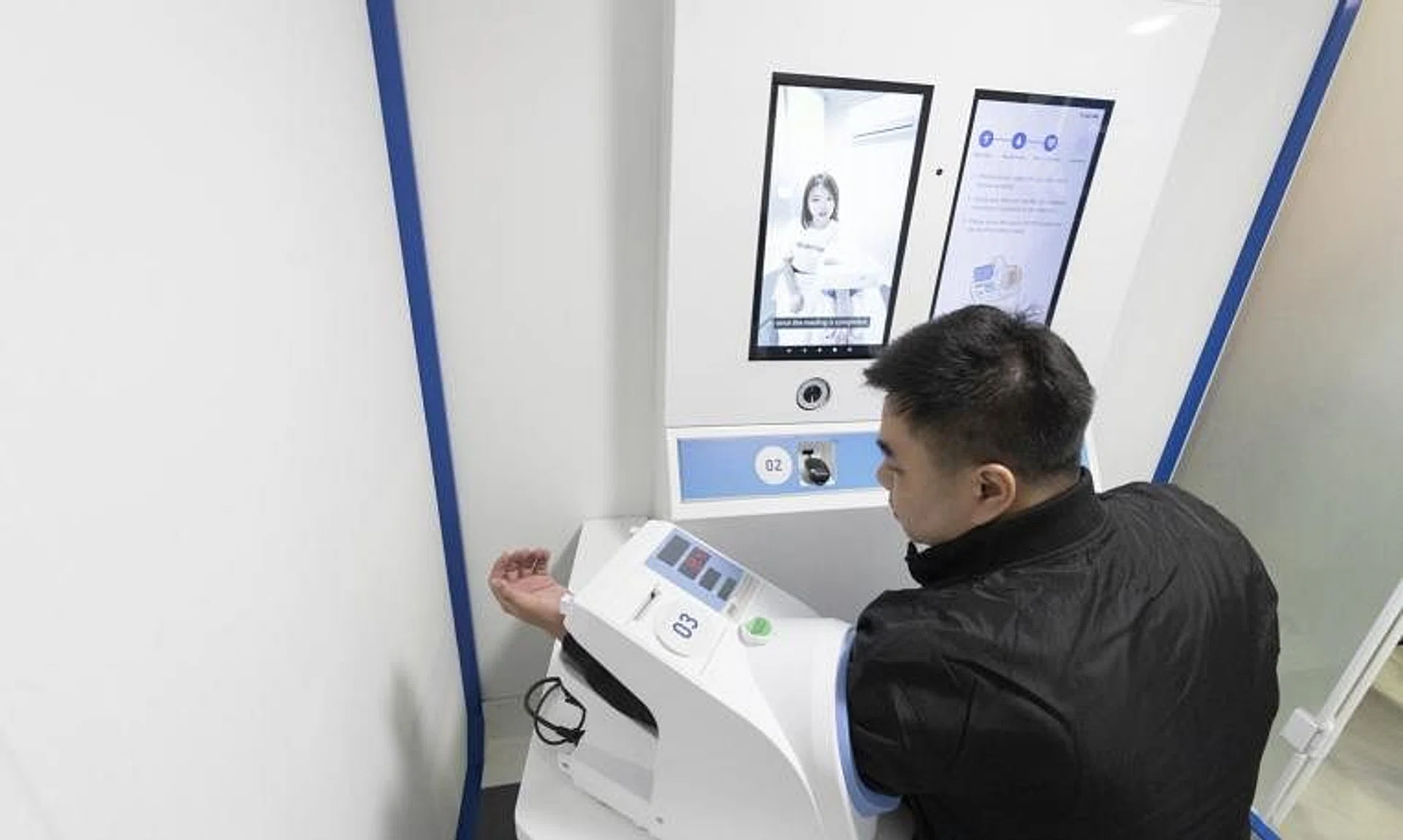 Sensors built into RP Medbot can measure a patient's height and weight, while a machine takes his blood pressure.