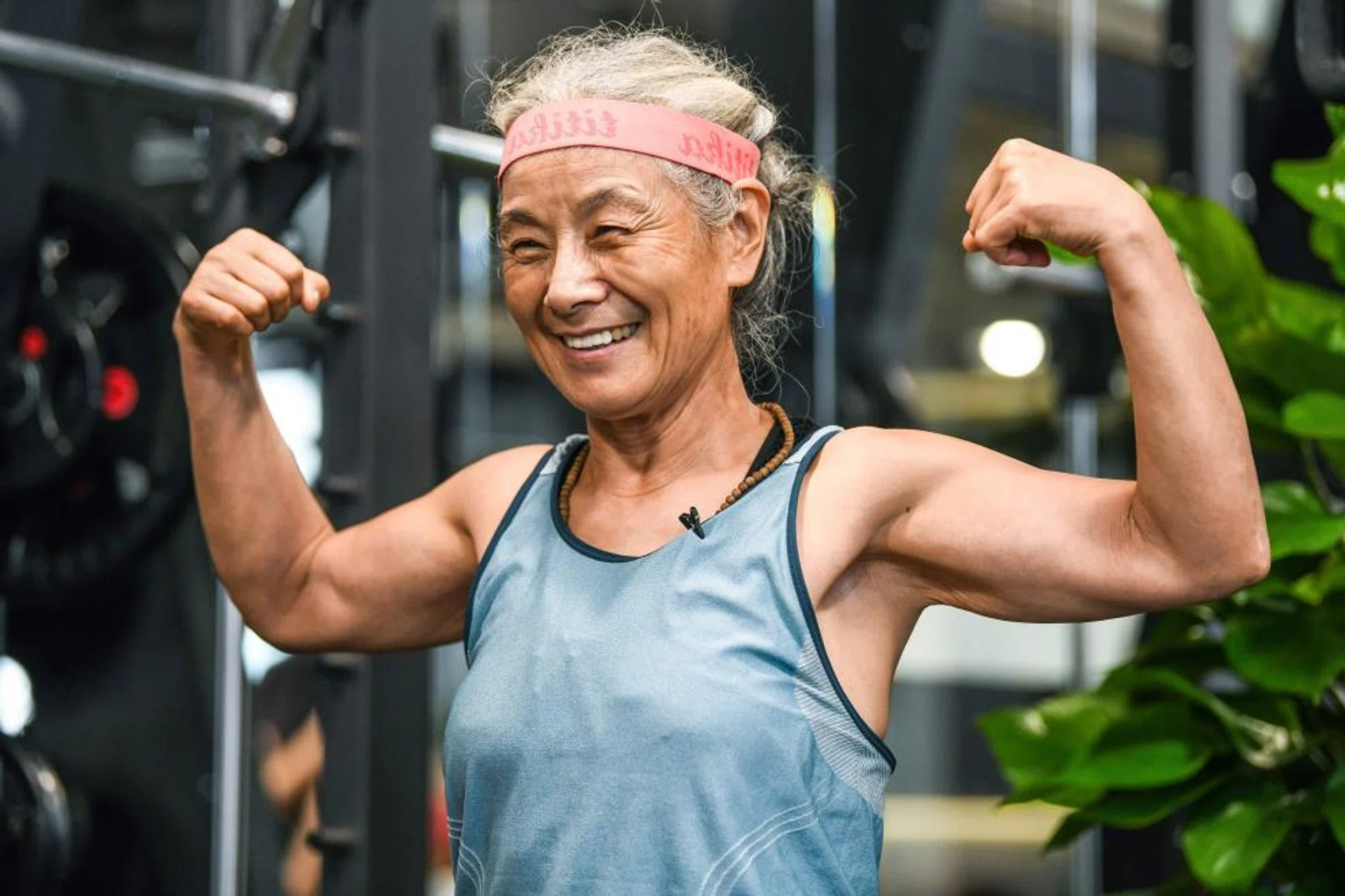 This photo taken on September 17, 2020 shows Chen Jifang, 70, posing for photographs at a gym in Shanghai. - The grandmother from Shanghai has become a minor celebrity in recent months in China as her newfound and unlikely love for working out made national headlines.