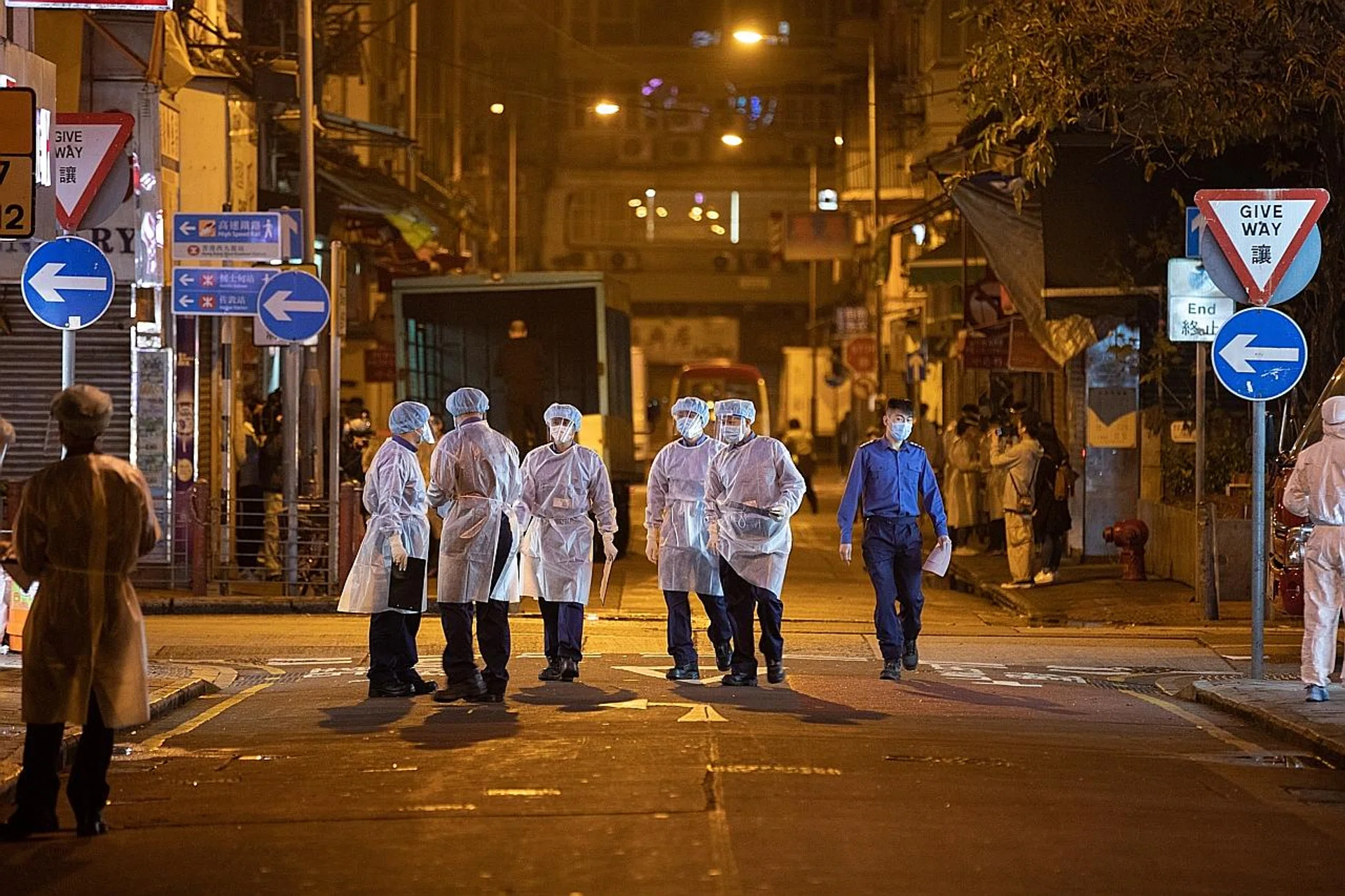 Civil servants in Jordan district in Hong Kong yesterday. The Hong Kong government lifted lockdown restrictions on several blocks where old and dilapidated buildings had been the centre of a Covid-19 outbreak. 