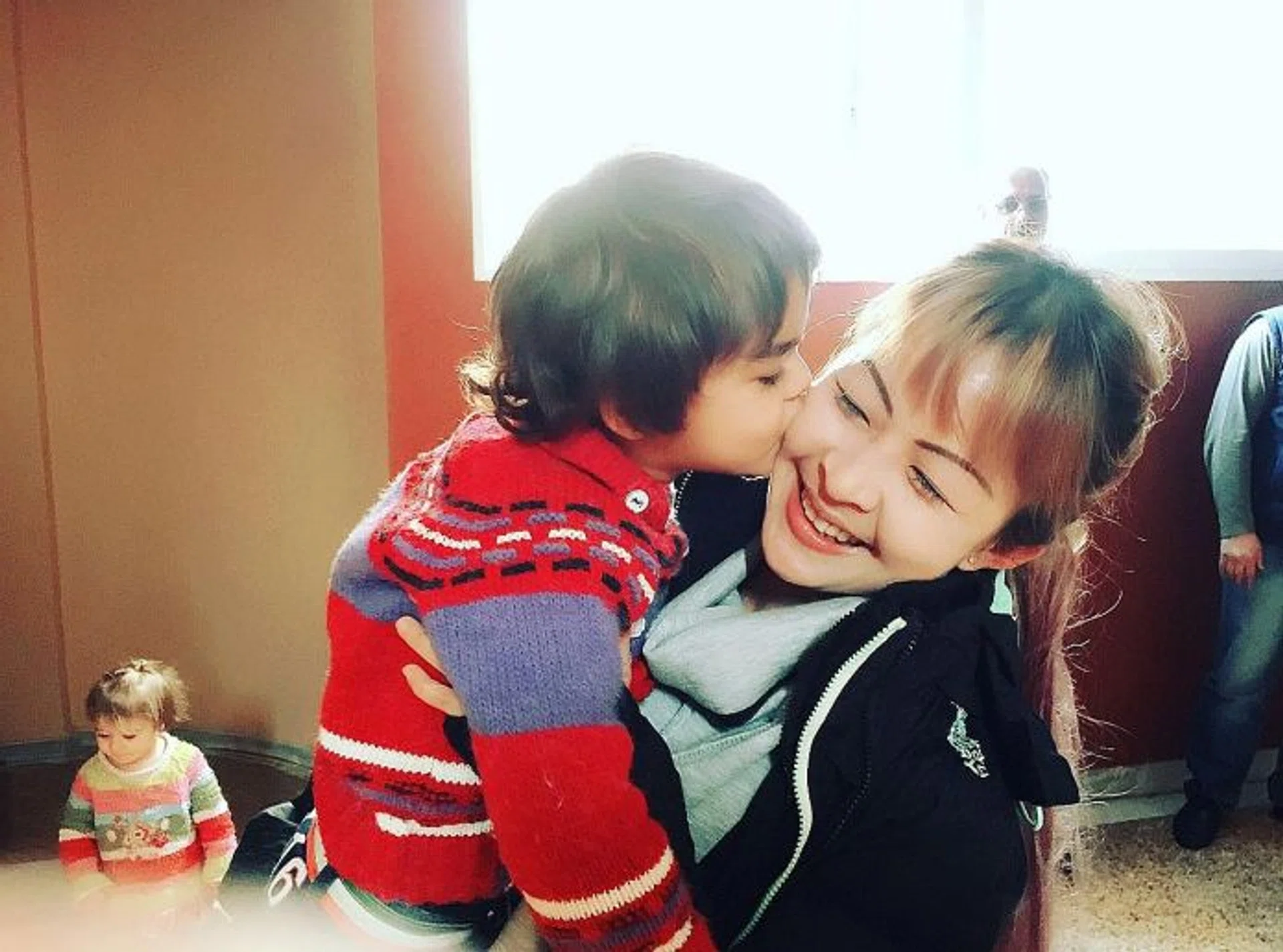 MAKING FRIENDS: (Above) Ms Madeleine Png with a Syrian child who ran to her and kissed her on the cheek.