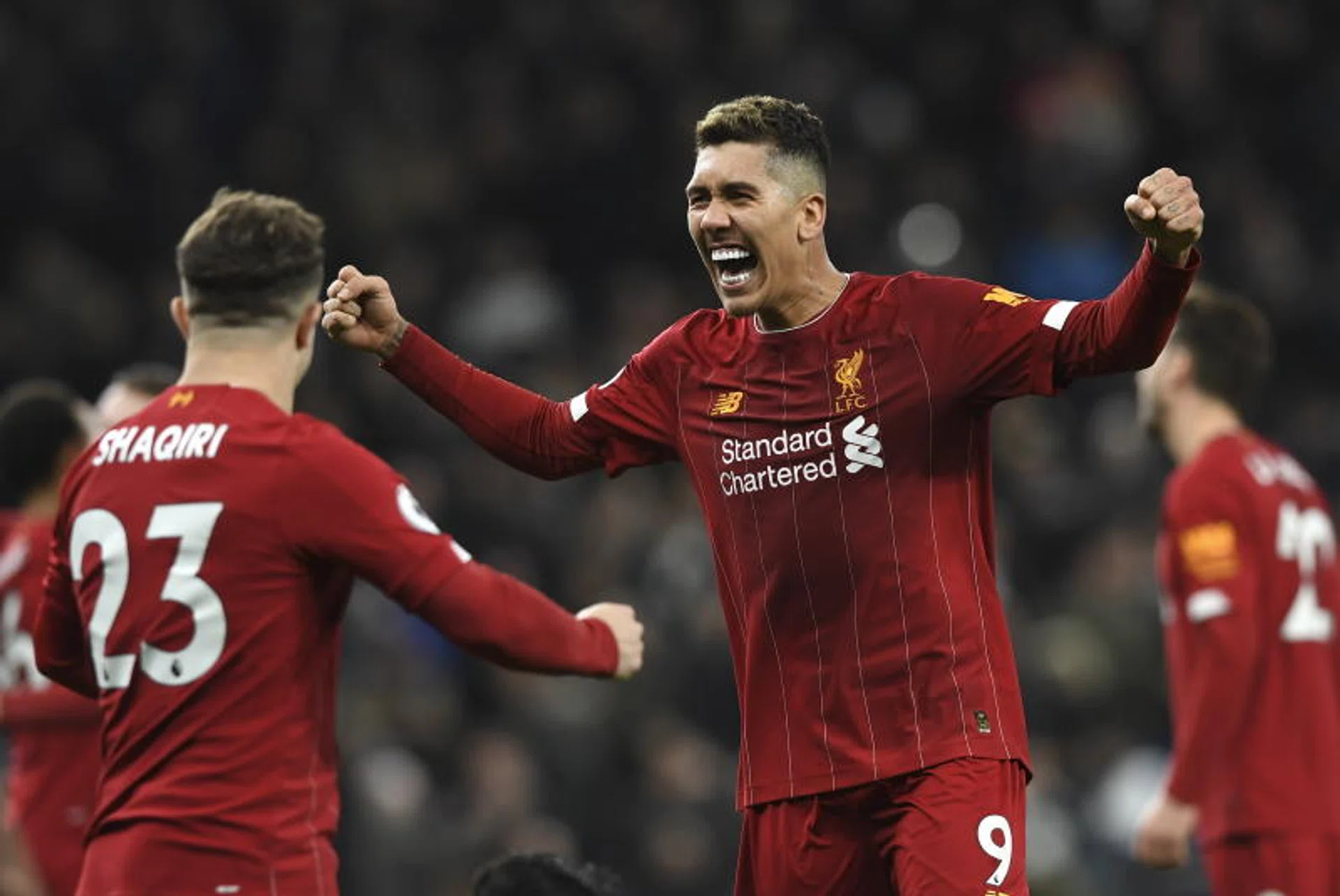 Roberto Firmino (right) celebrates with Xherdan Shaqiri after Liverpool's 1-0 win over Tottenham Hotspur.