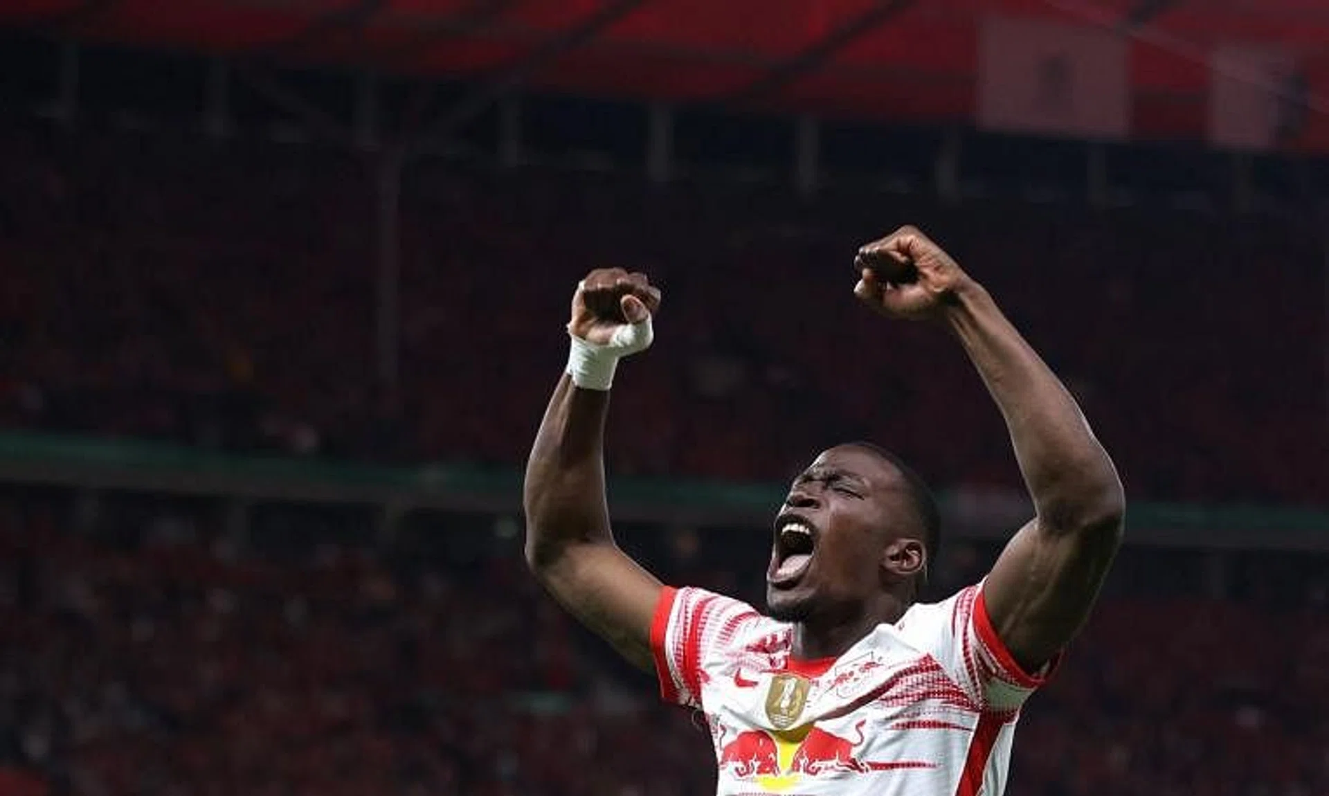 Nordi Mukiele celebrates after Leipzig won the German Cup final against SC Freiburg on May 21, 2022.