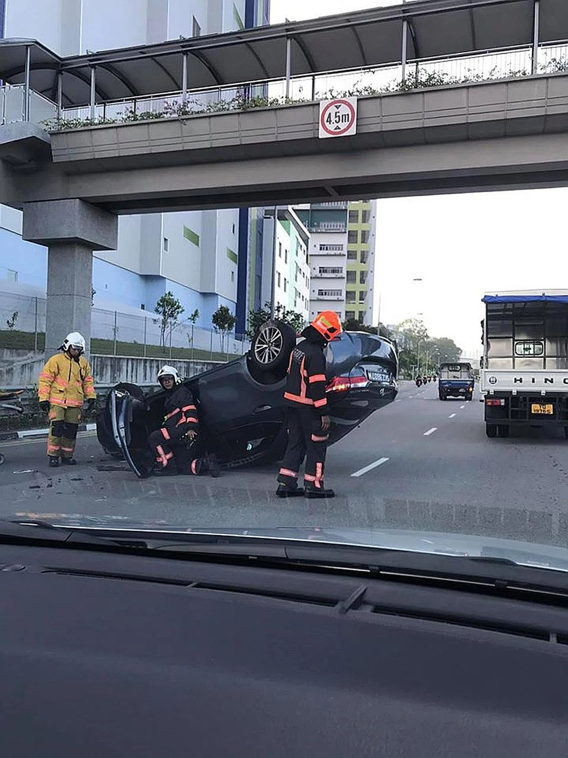 The overturned Toyota Altis in the accident at the junction of Woodlands Road and Mandai Road which caused two lanes to be closed.  