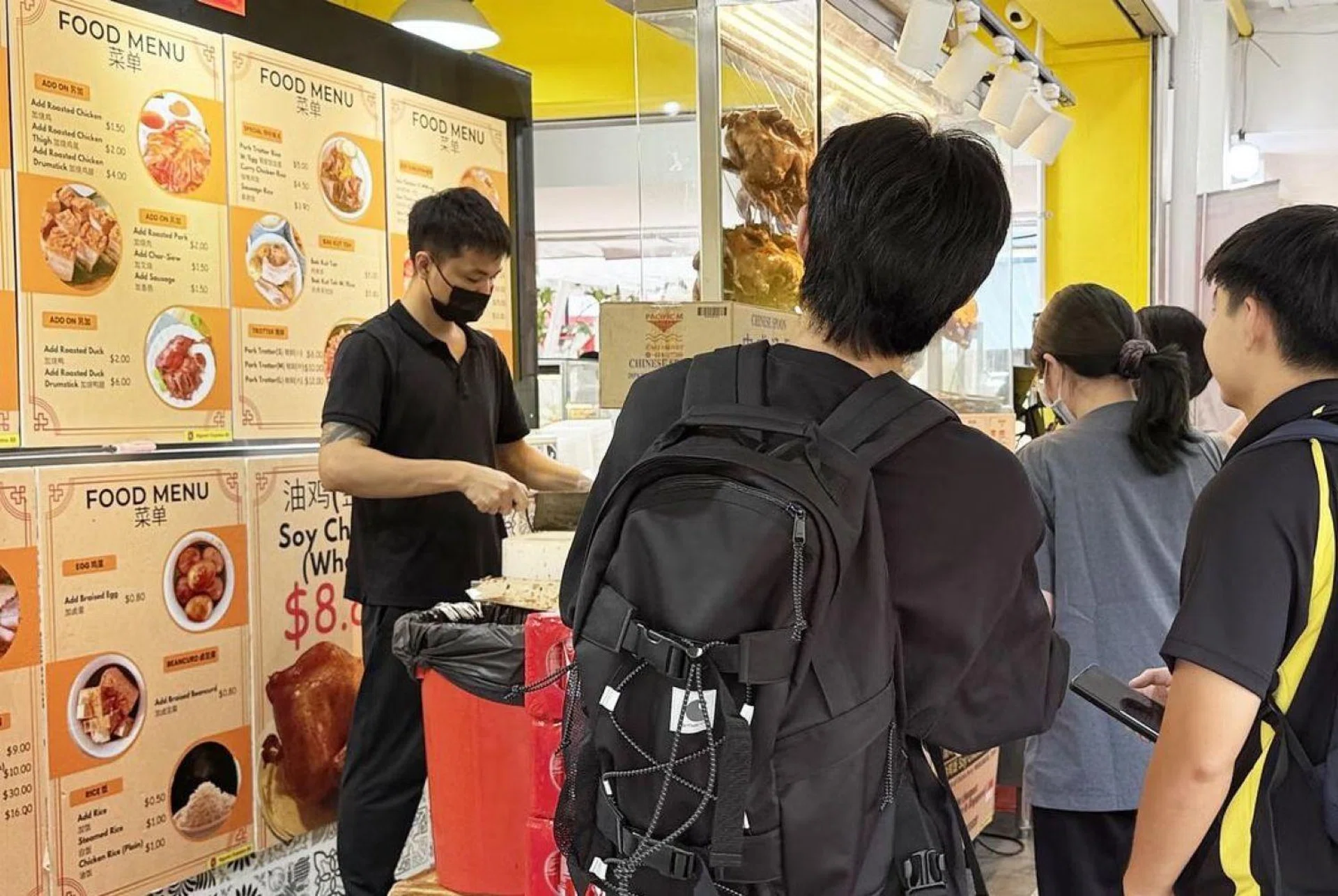 Customers flocking to chicken rice stall for a $1.90 meal.