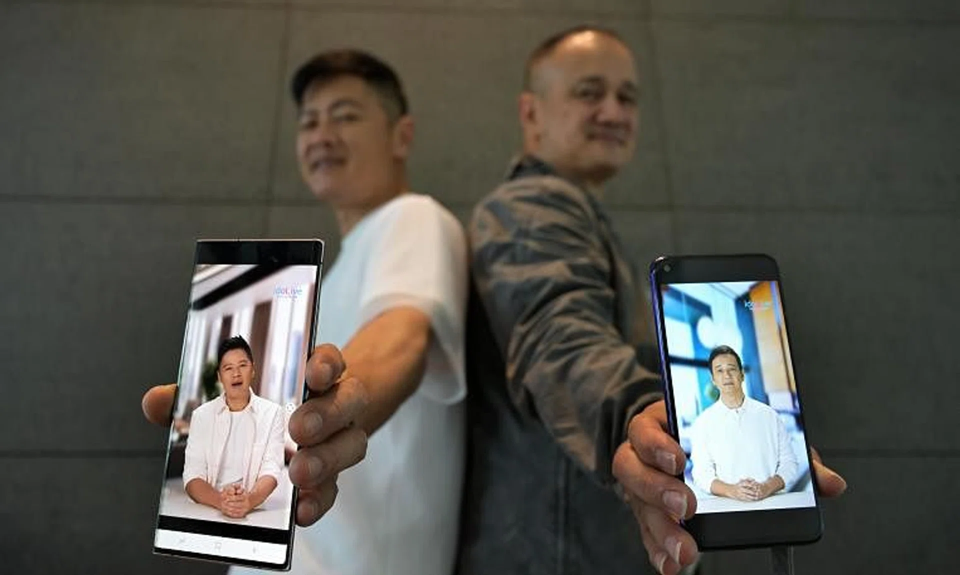 Local artistes Li Nanxing (left) and Gurmit Singh with their AI-generated avatars at a press conference to launch IdoLive on March 22.