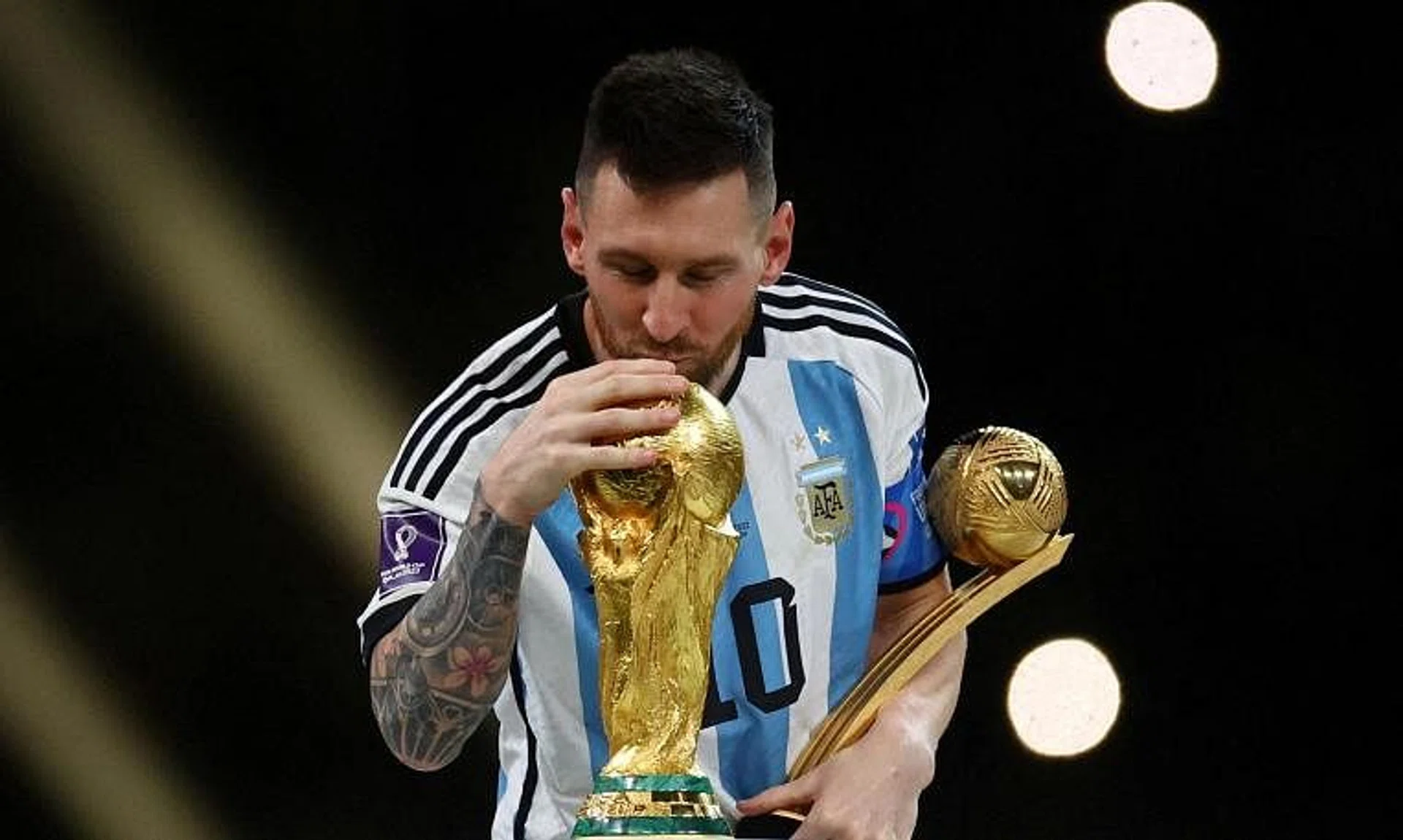 Argentina's Lionel Messi kissing the World Cup trophy after receiving the Golden Ball award at Qatar 2022.