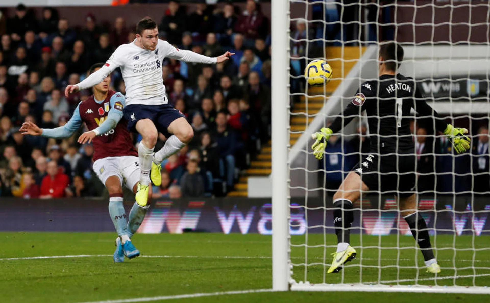 Liverpool's Andy Robertson (in white) scoring their first goal off Sadio Mane's cross. 