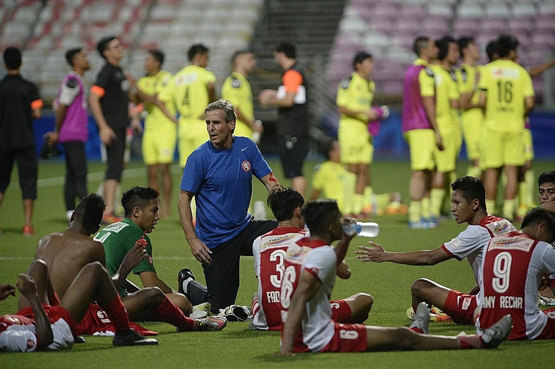 Juergen Raab (far left) speaks to his Young Lions players after a loss to Hougang United in July 2015.