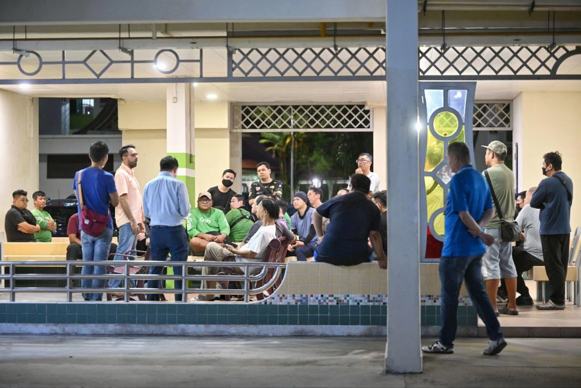 A group of about 30 delivery riders meeting with Leader of the Opposition Pritam Singh (in orange) at 615 Bedok Reservoir Road on July 7.