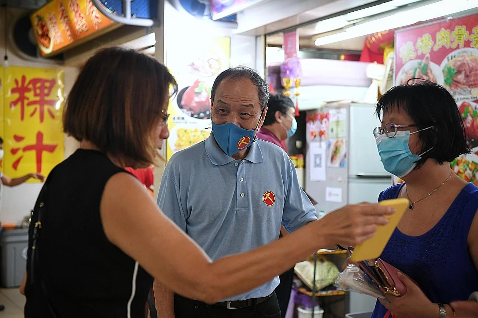 Former WP chief Low Thia Khiang speaking to residents during the party's walkabout at Hainan Market in Hougang Avenue 1 yesterday. 