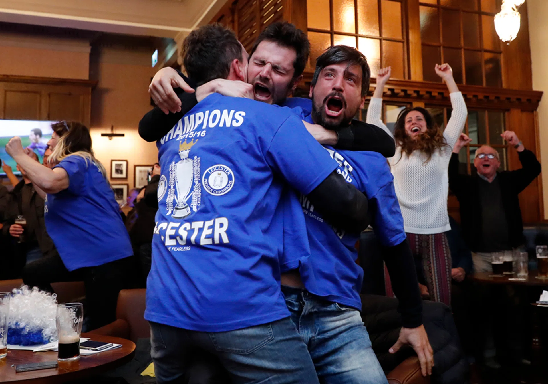Fans celebrate  in pub in Leicester as the Chelsea v Tottenham Hotspur game ends in a draw