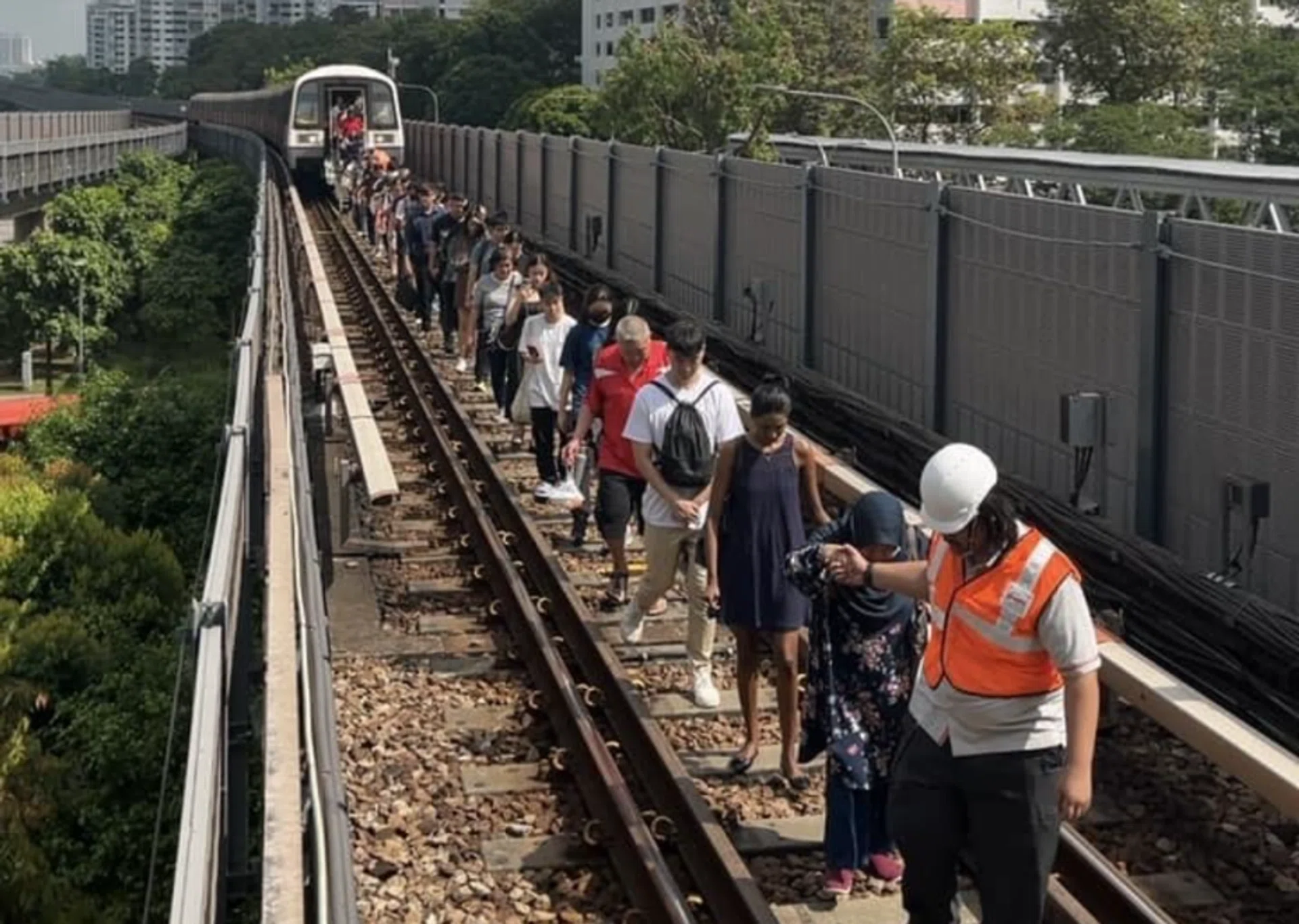 Commuters being guided to the station platform.