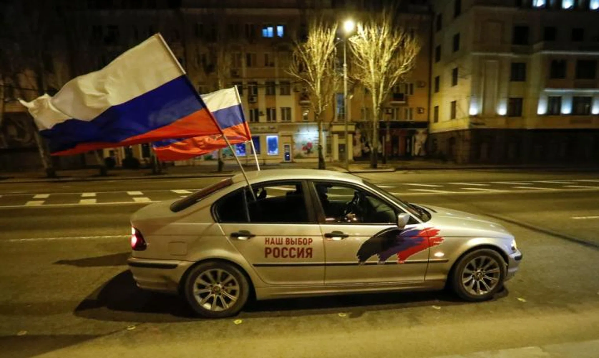 A car with Russia flags attached driving through the separatist-controlled city of Donetsk, Ukraine, on Feb 21, 2022.