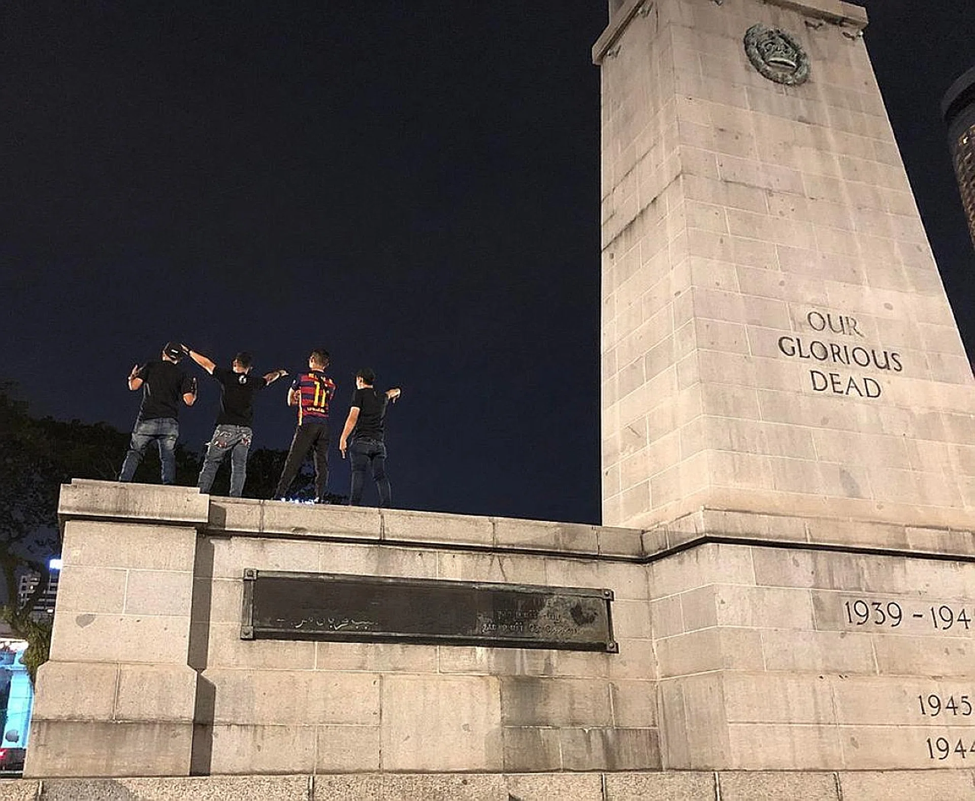 A photo of four young men standing on The Cenotaph striking poses has drawn flak from netizens, who are calling the act disrespectful and in bad taste. 