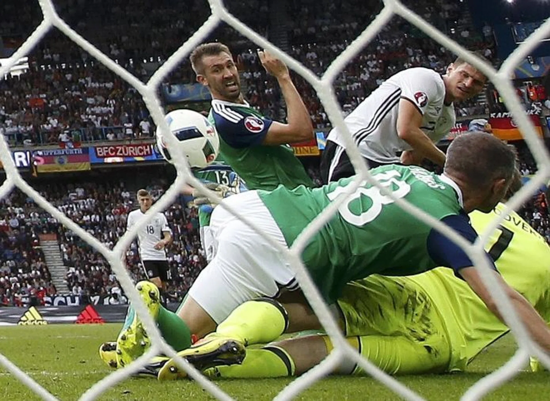 ONE UP: Mario Gomez (top right) putting the ball past Northern Ireland goalkeeper Michael McGovern for Germany's only goal.  