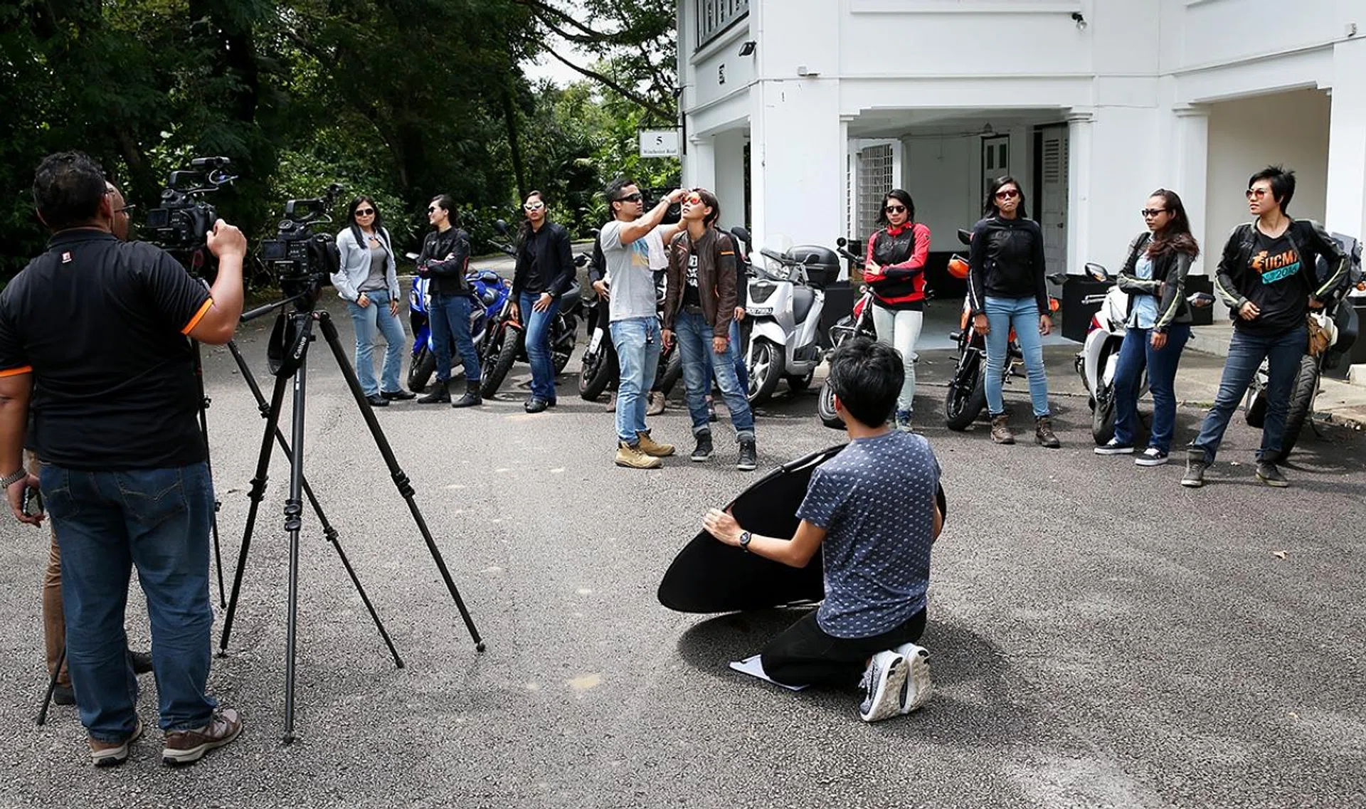 Ms Nafisah Anwar getting a wipe down from her fiance, Mr Ariffin Omar, who volunteered to help out in the scorching heat. She was shooting a series on female bikers.