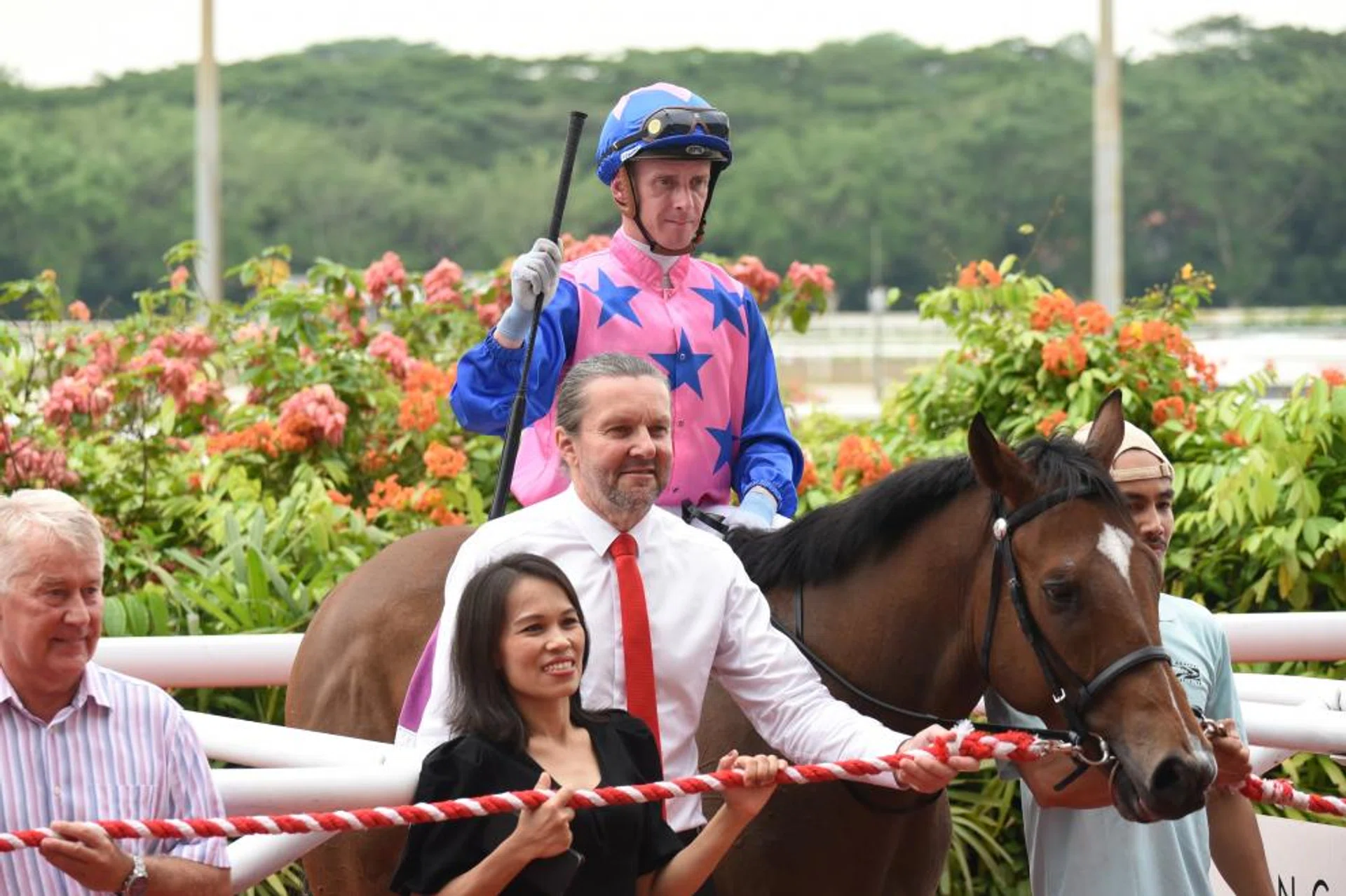 Greatham Boy (Daniel Moor) after landing the Group 3 Singapore Golden Horseshoe over 1,200m on July 23, 2023. The Australian-bred was then trained by Michael Clements (in tie). 
