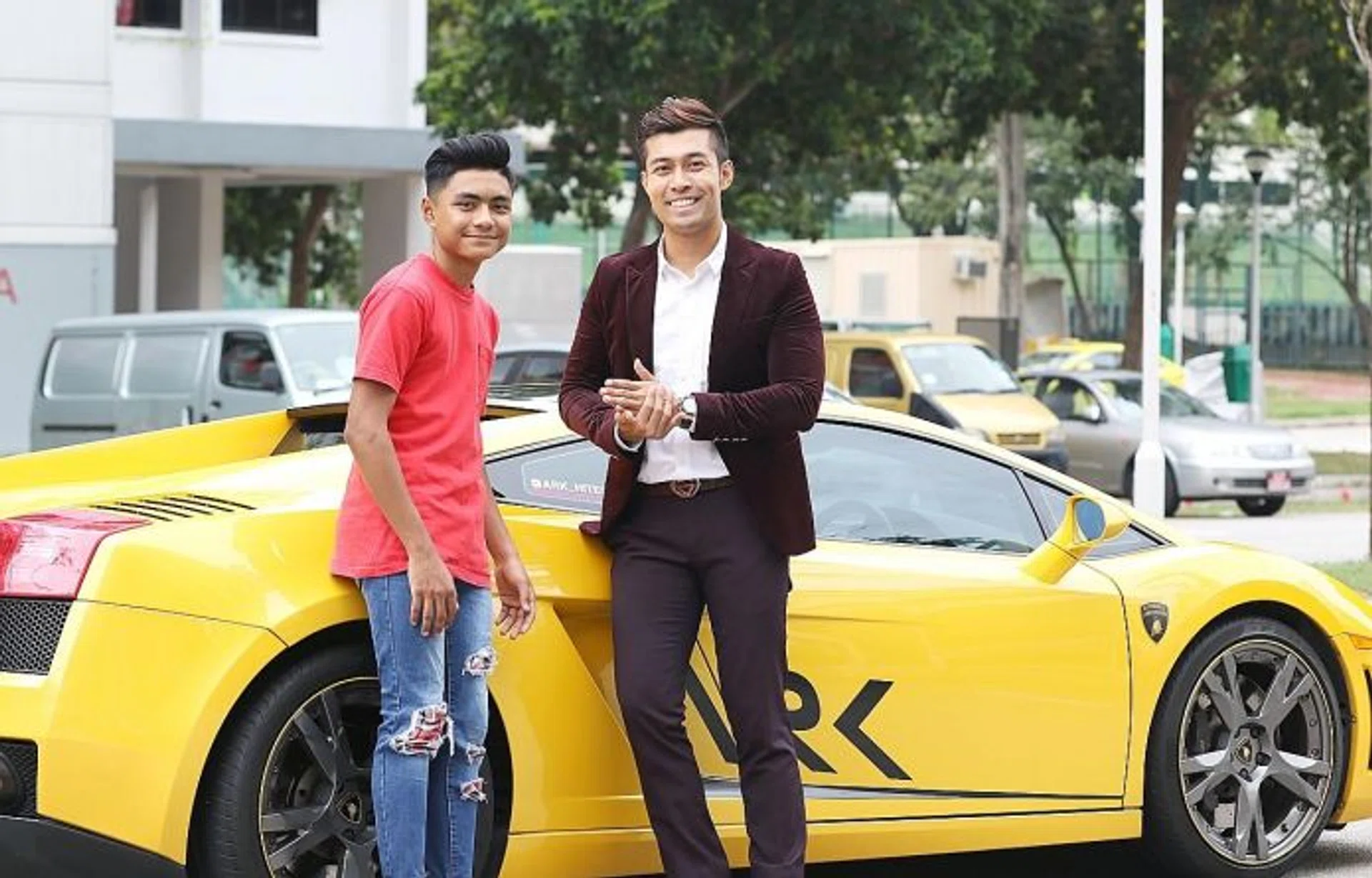 RESOLVED: Teen mountain biker Izzadnaff Abdul Qusyairl (left) with the owner of the supercar, Mr Aaron Rylan Keder.