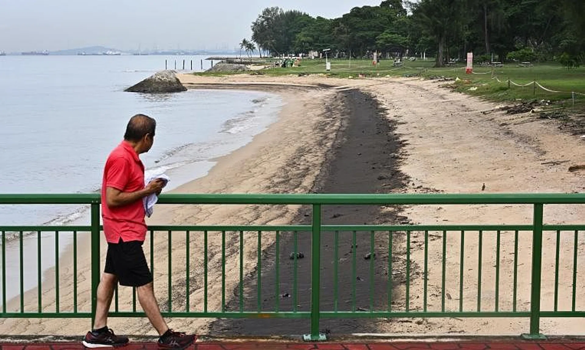 The oil spill along the shoreline of East Coast Park as seen from Bedok Jetty at about 10am on June 16.