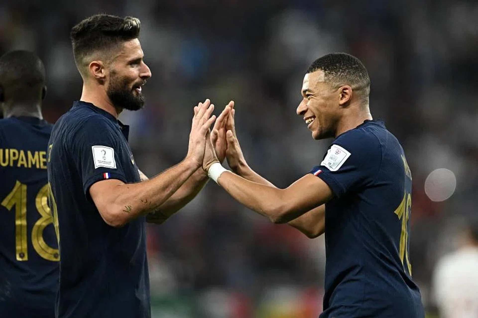 France's Kylian Mbappe celebrates scoring their second goal against Poland with Olivier Giroud. 
