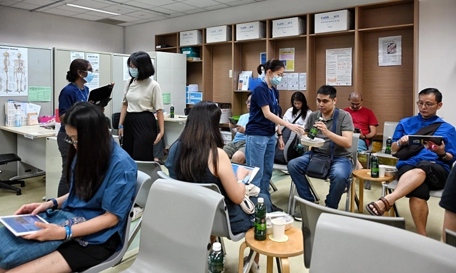 Singapore Population Health Studies staff with participants undergoing health screening at the NUS Saw Swee Hock School of Public Health on Nov 9.