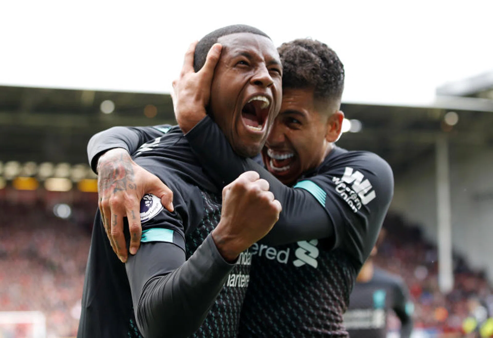 Georginio Wijnaldum (left) celebrating with Roberto Firmino after scoring their winner.