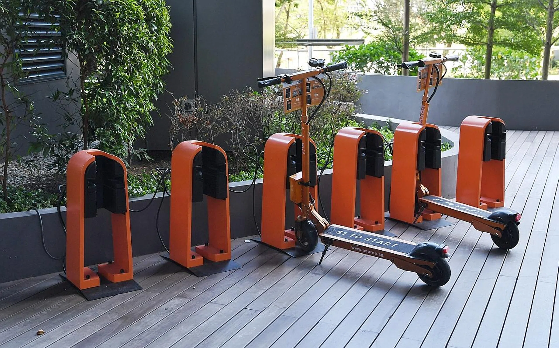 Neuron Mobility e-scooters parked outside the Ascent building on Science Park Drive. TNP PHOTO: KHALID BABA