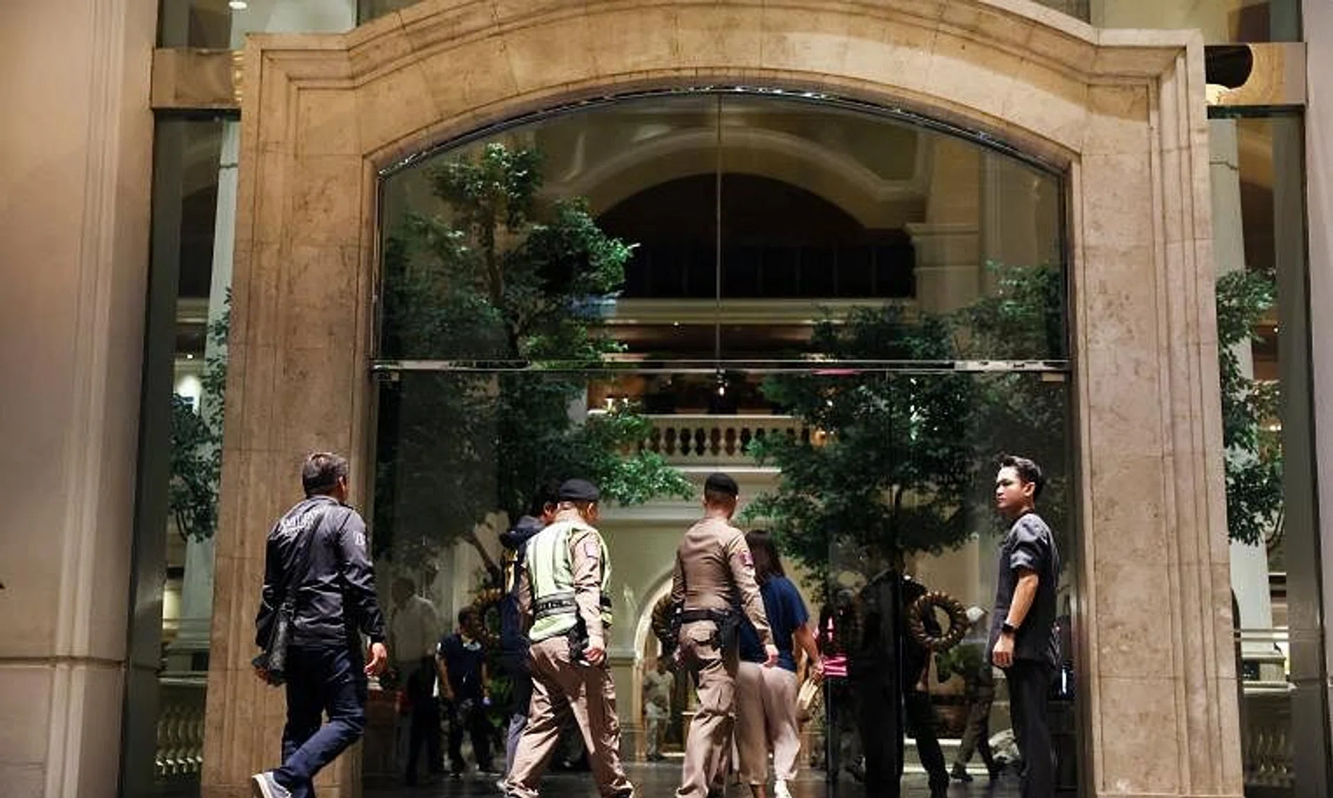 Policemen seen in the Grand Hyatt Erawan hotel, where at least six people were reported dead, in Bangkok on July 16.