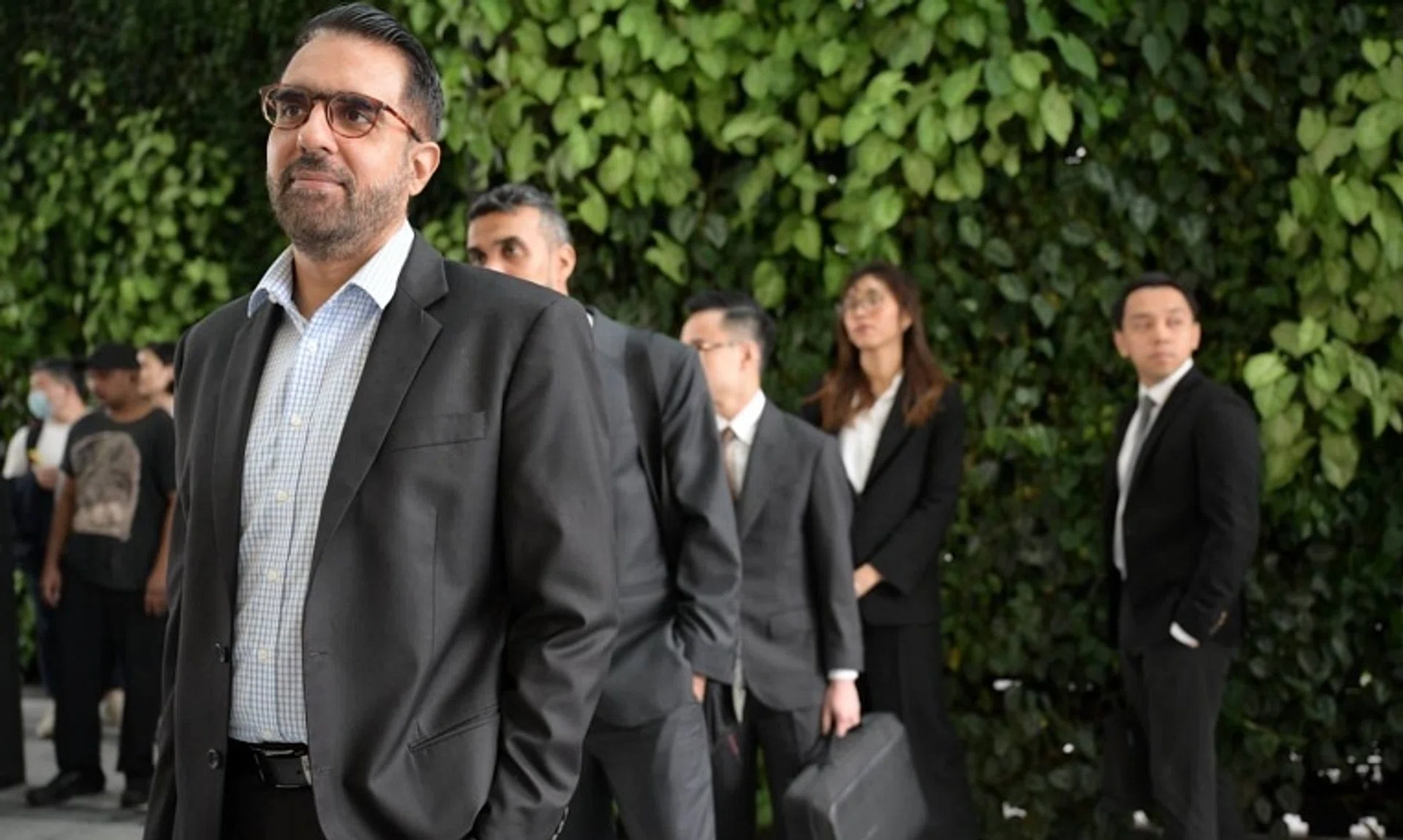 WP chief Pritam Singh queueing at the State Courts ahead of his hearing on Nov 6.