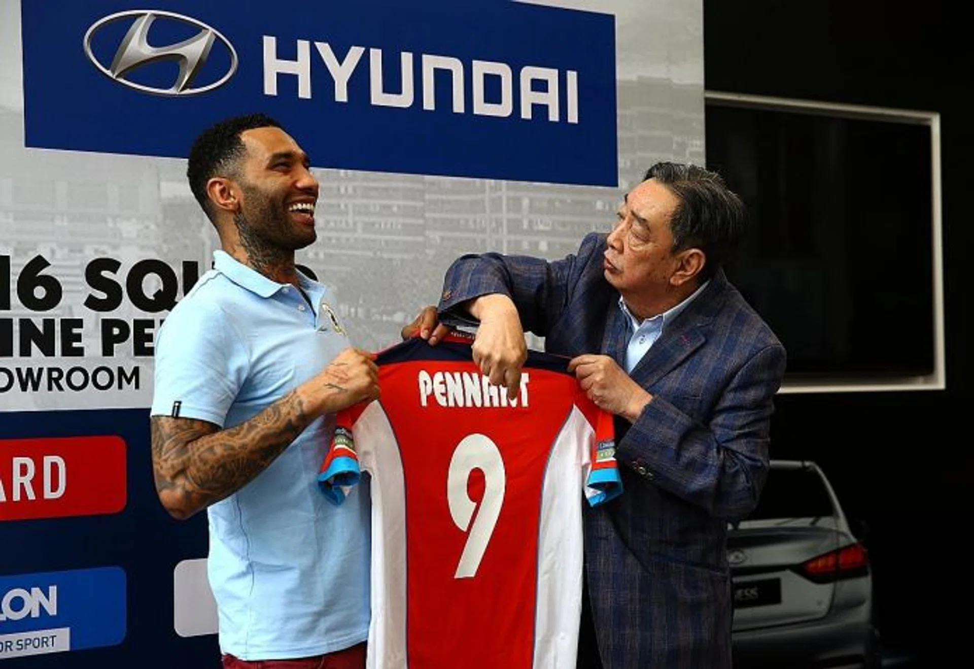 ALL SMILES: New Tampines Rovers star Jermaine Pennant (above, left) shares a light-hearted moment with former club chairman Teo Hock Seng.  