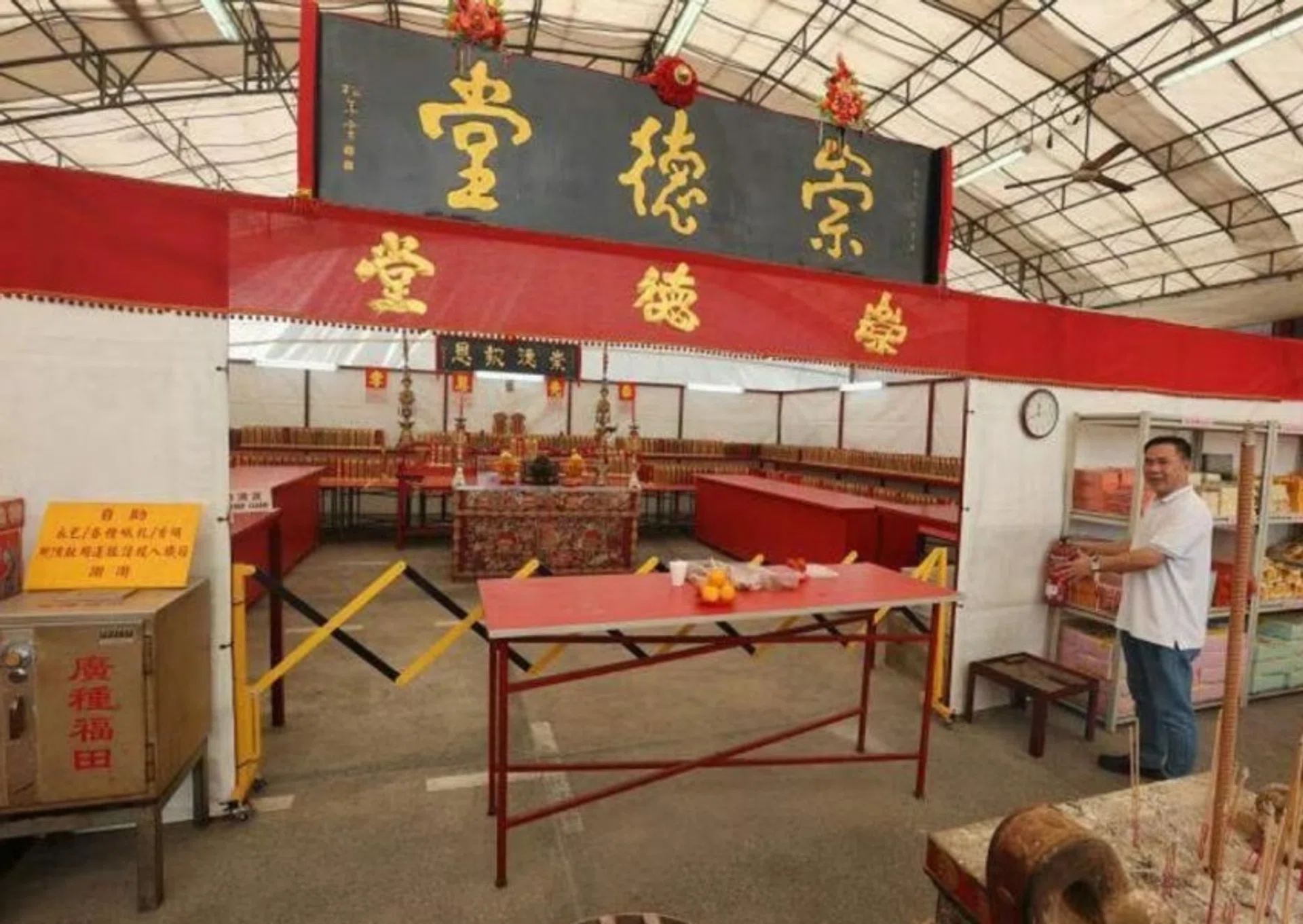 Yu, the temple's caretaker, pointing to where the missing safe used to be.