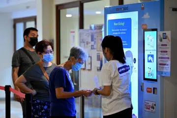 First day of free mask collection runs smoothly; residents pleased with different sizes, design