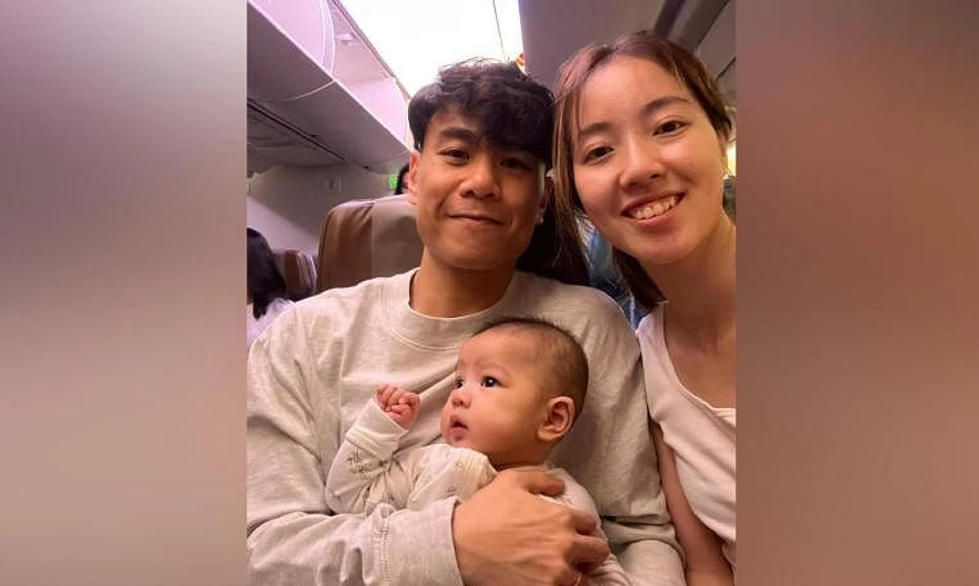 Singaporean fencers Samson Lee (left) and Cheryl Lim with their son Steffan on the flight to Milan.