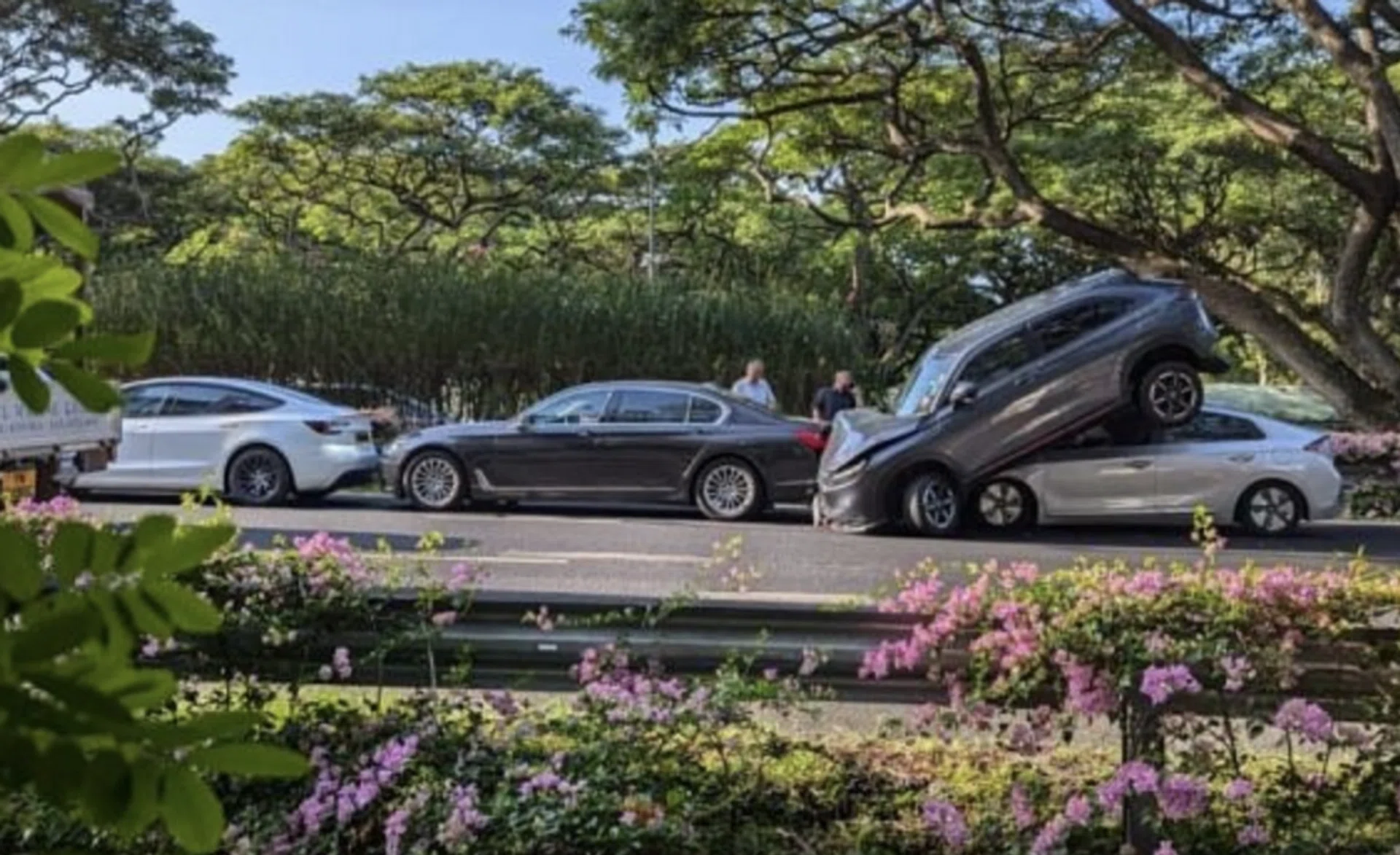 One of the cars – with its front bumper damaged – is seen atop another car in a photo shared on Telegram. 